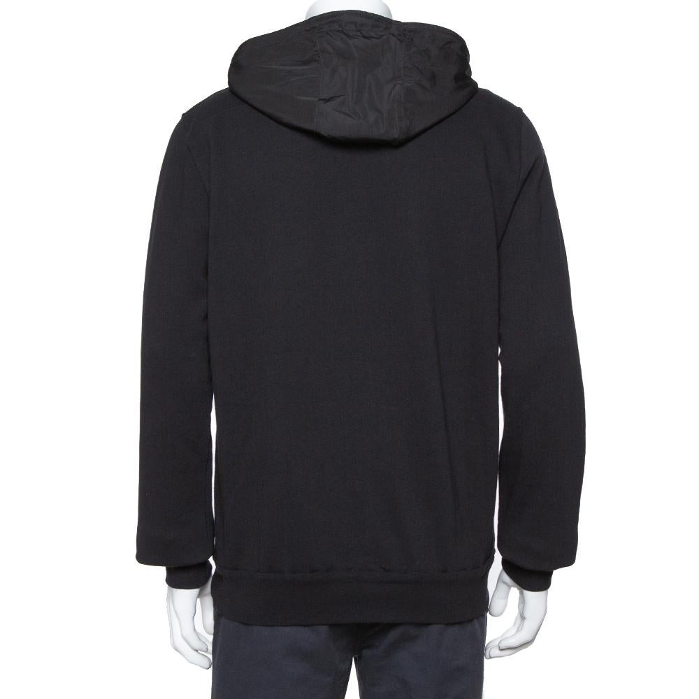 Get this Dior hoodie and flaunt an effortless urbane look on any day. It features a tonal paneled design made from different fabrics for a simple yet stylish appeal. The creation features a drawstring hood, zipper fastening, and long sleeves.

