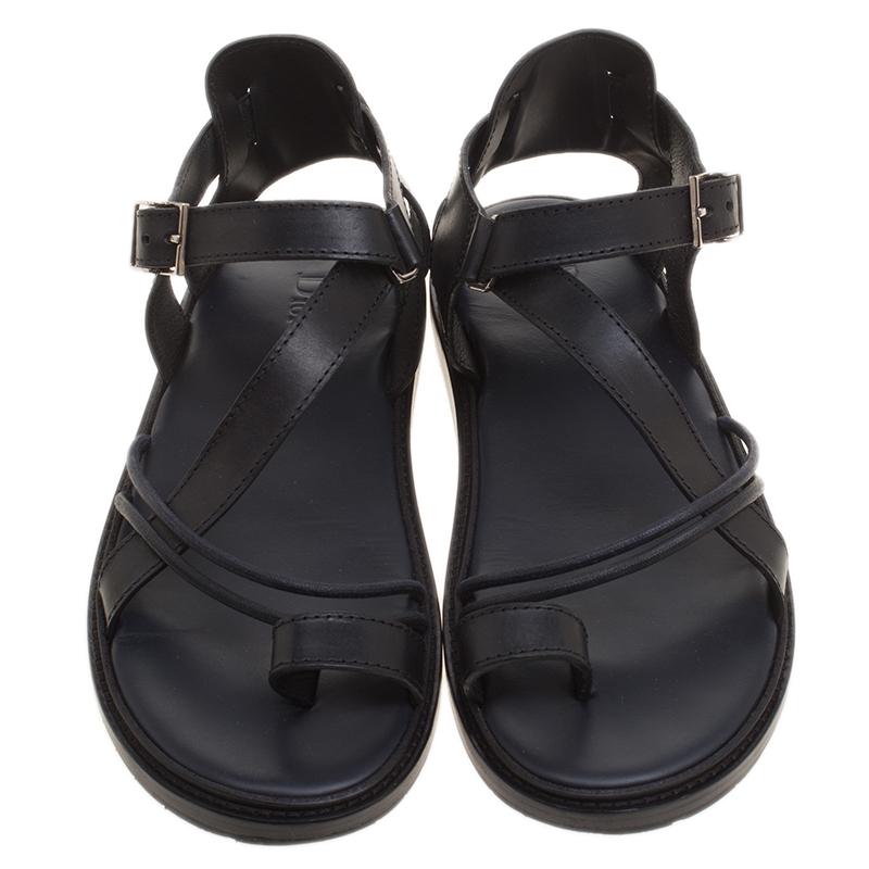 Criss-Crossing straps and a comfortable in-sole characterize this pair of sandals from the house of Dior. Crafted exquisitely, using black leather that imparts a look of pure luxuriousness, these sandals can become wardrobe essentials due to their