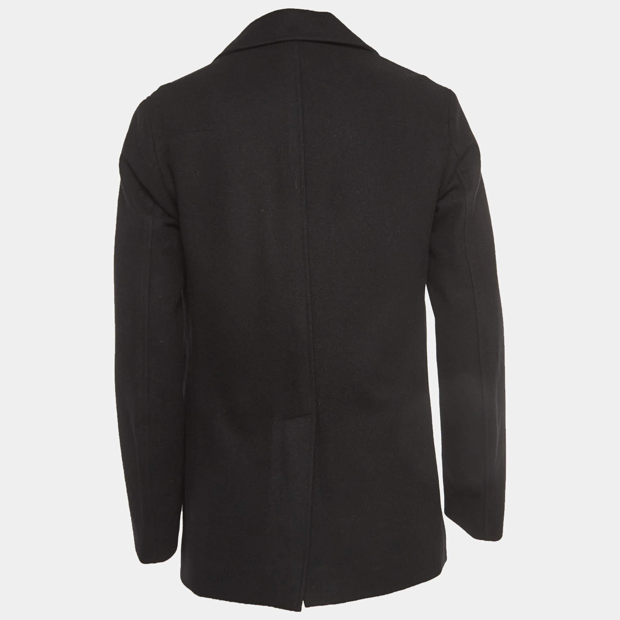 Crafted by Dior Homme, this exquisite black wool double-breasted coat exudes sophistication and elegance. Its tailored silhouette accentuates the wearer's form, while the luxurious wool fabric provides warmth and style. Perfect for any occasion,