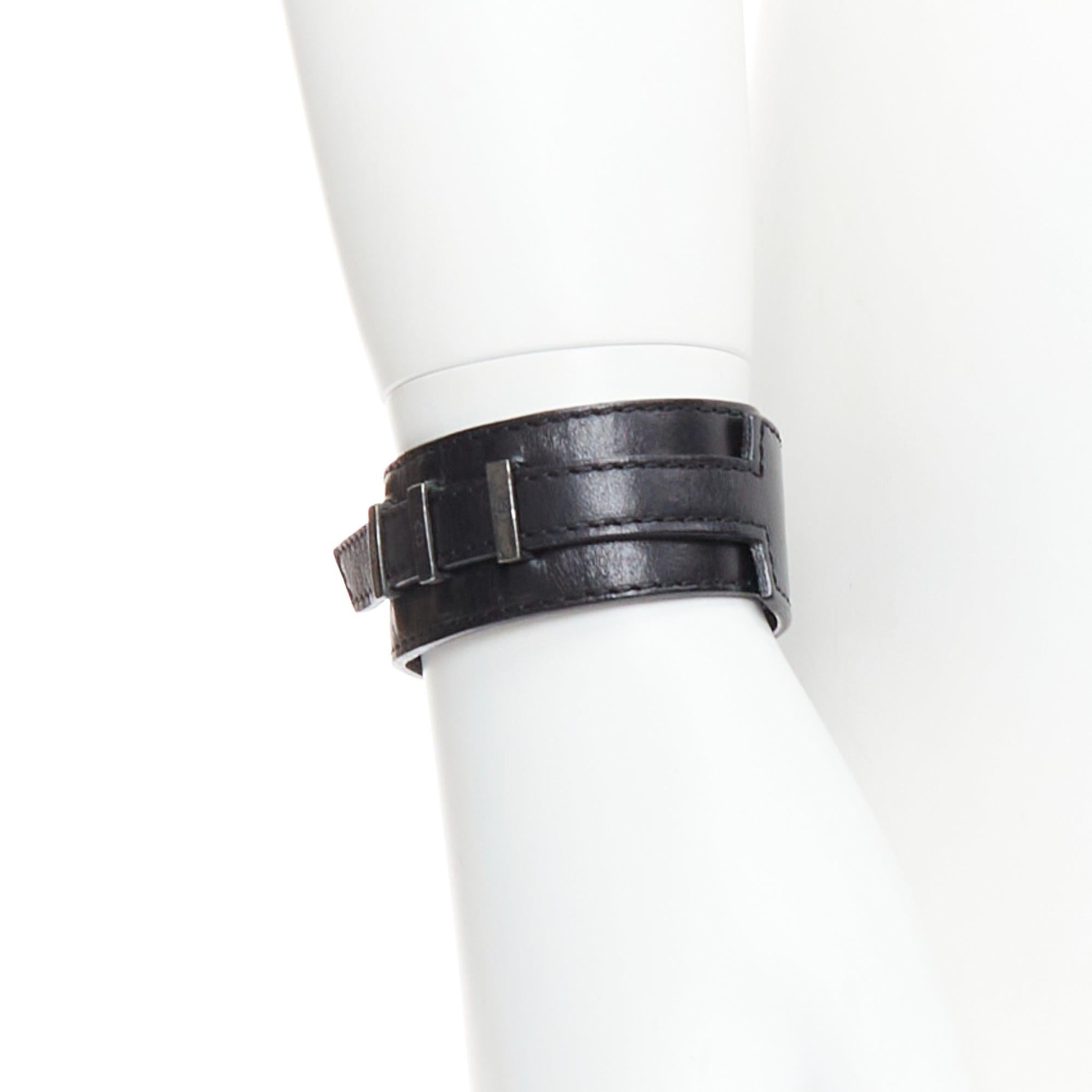 DIOR HOMME Hedi Slimane black leather CD logo loop through cuff
Reference: PRWU/A00175
Brand: Dior
Designer: Hedi Slimane
Collection: HOMME
Material: Leather, Metal
Color: Black, Silver
Pattern: Solid
Closure: Loop Through
Lining: Black