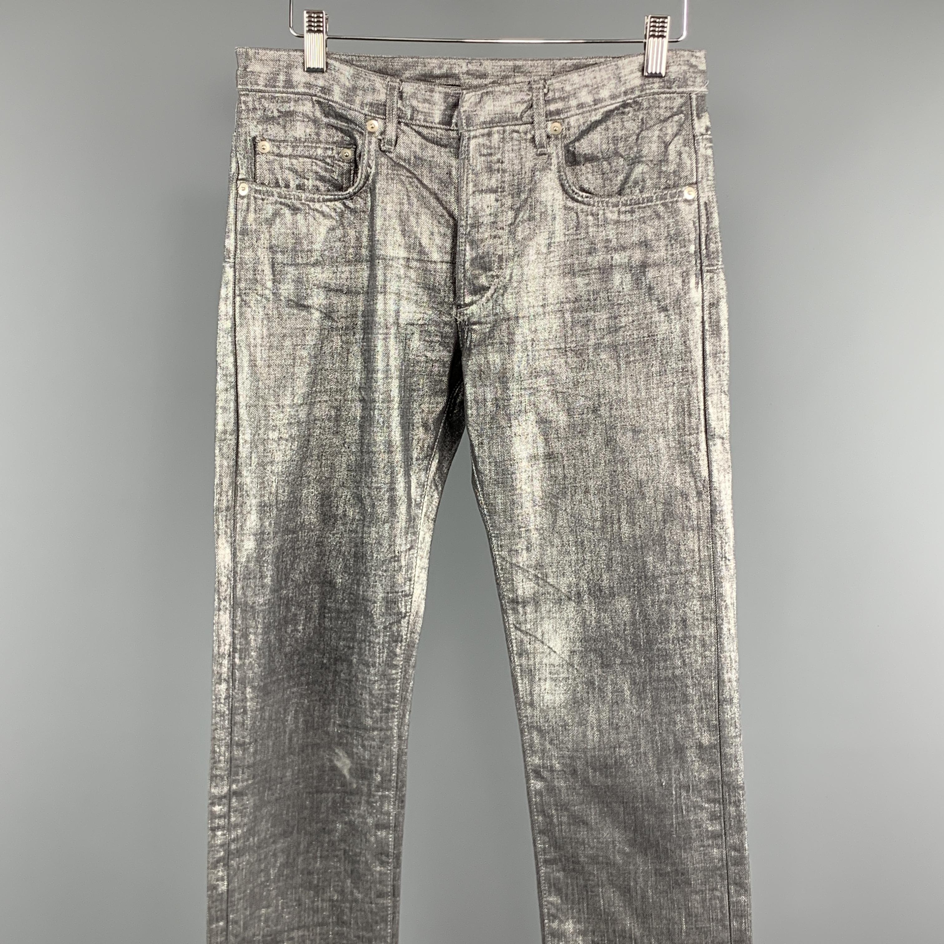 DIOR HOMME Jeans comes in a silver metallic denim featuring a slit fit, front tab, and a button fly closure. Made in Japan. 

Excellent Pre-Owned Condition.
Marked: 28

Measurements:

Waist: 28 in. 
Rise: 8.5 in. 
Inseam: 38 in. 