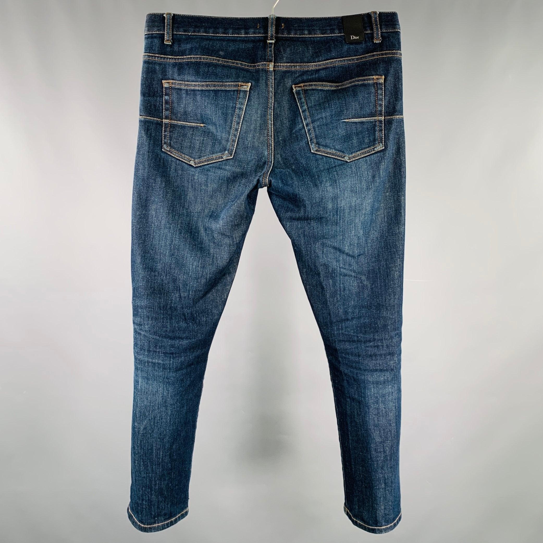 DIOR HOMME jeans
in a blue washed cotton stretch blend denim featuring a five pockets style, yellow contrast stitching, and button fly closure. Made in Italy.Very Good Pre-Owned Condition. Minor signs of wear. 

Marked:   31 

Measurements: 
 