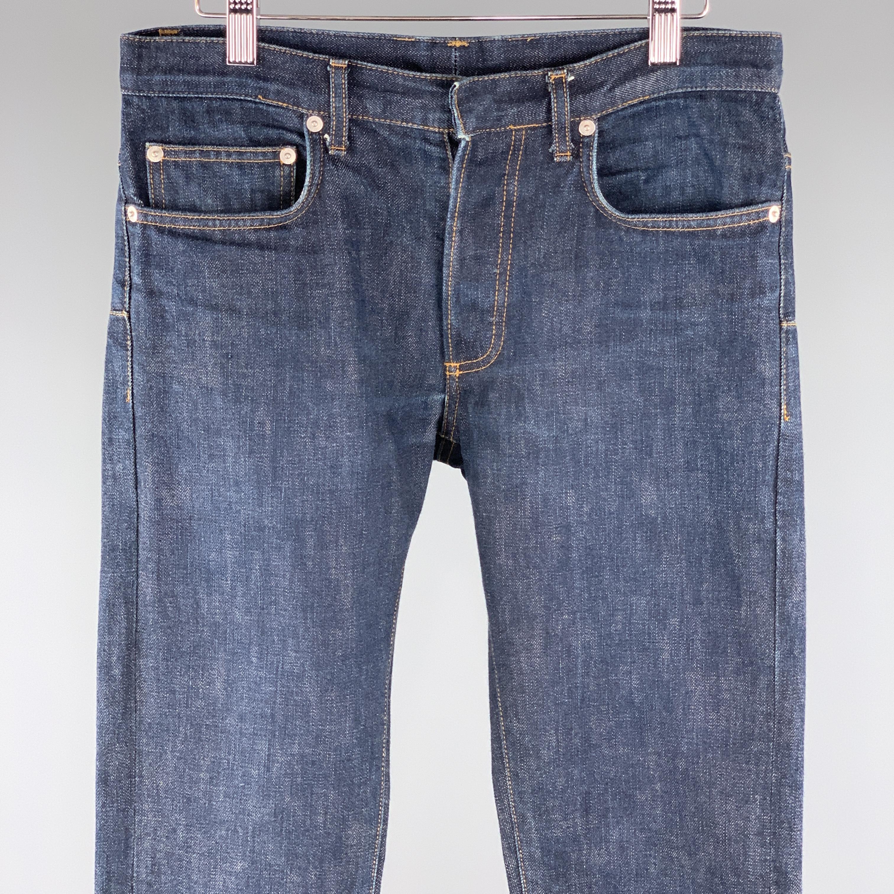 DIOR HOMME jeans comes in a indigo wash denim featuring a skinny fit style, contrast stitching, and a button fly closure. Made in Italy.
 
Very Good Pre-Owned Condition.
Marked: 31
 
Measurements:
 
Waist: 33 in.
Rise: 8 in.
Inseam: 29.5 in.