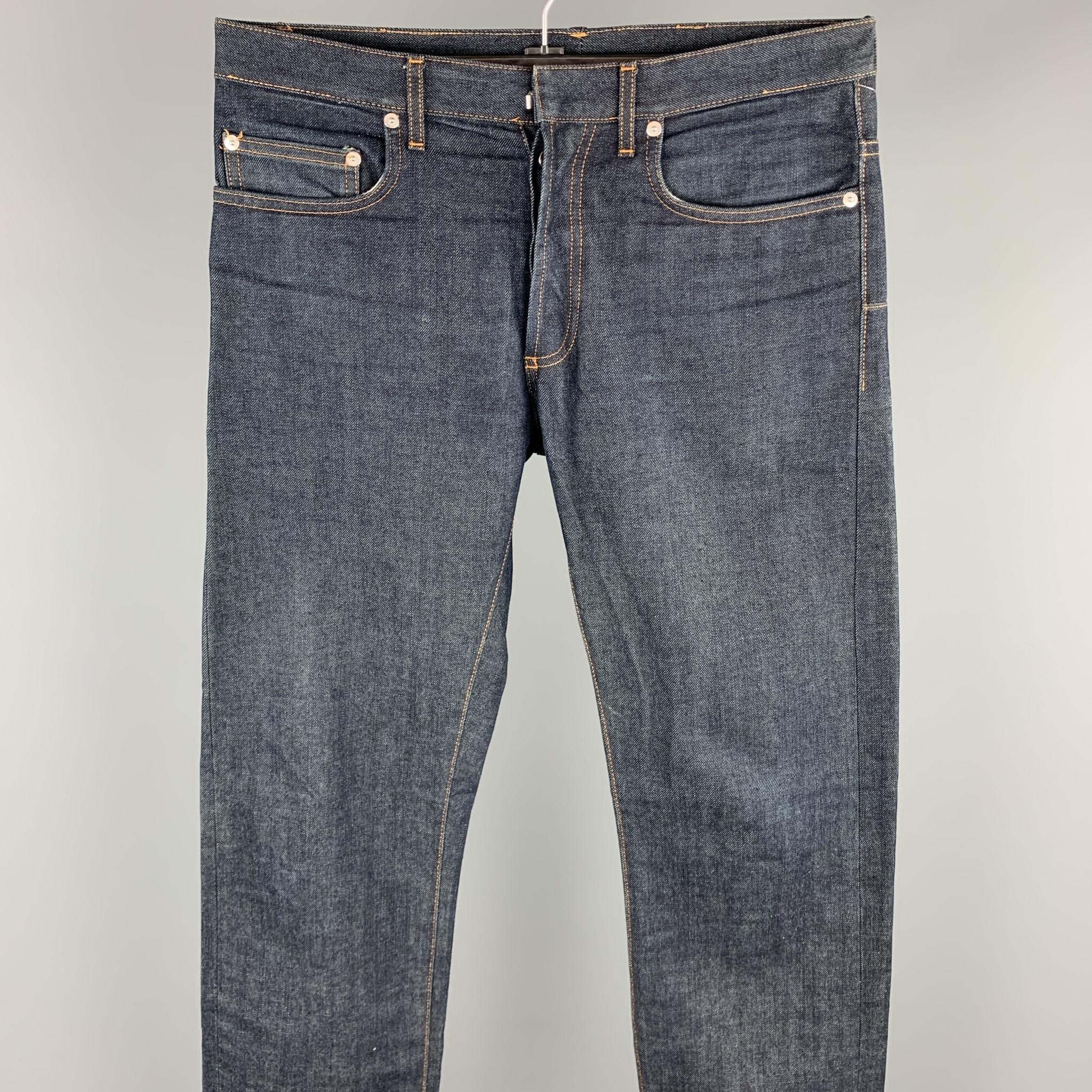DIOR HOMME jeans comes in a indigo denim with contrast stitching featuring contrast stitching and a button fly closure. As-Is. Made in Italy.

Very Good Pre-Owned Condition.
Marked: 32

Measurements:

Waist: 34 in.
Rise: 9 in. 
Inseam: 32.5 in. 