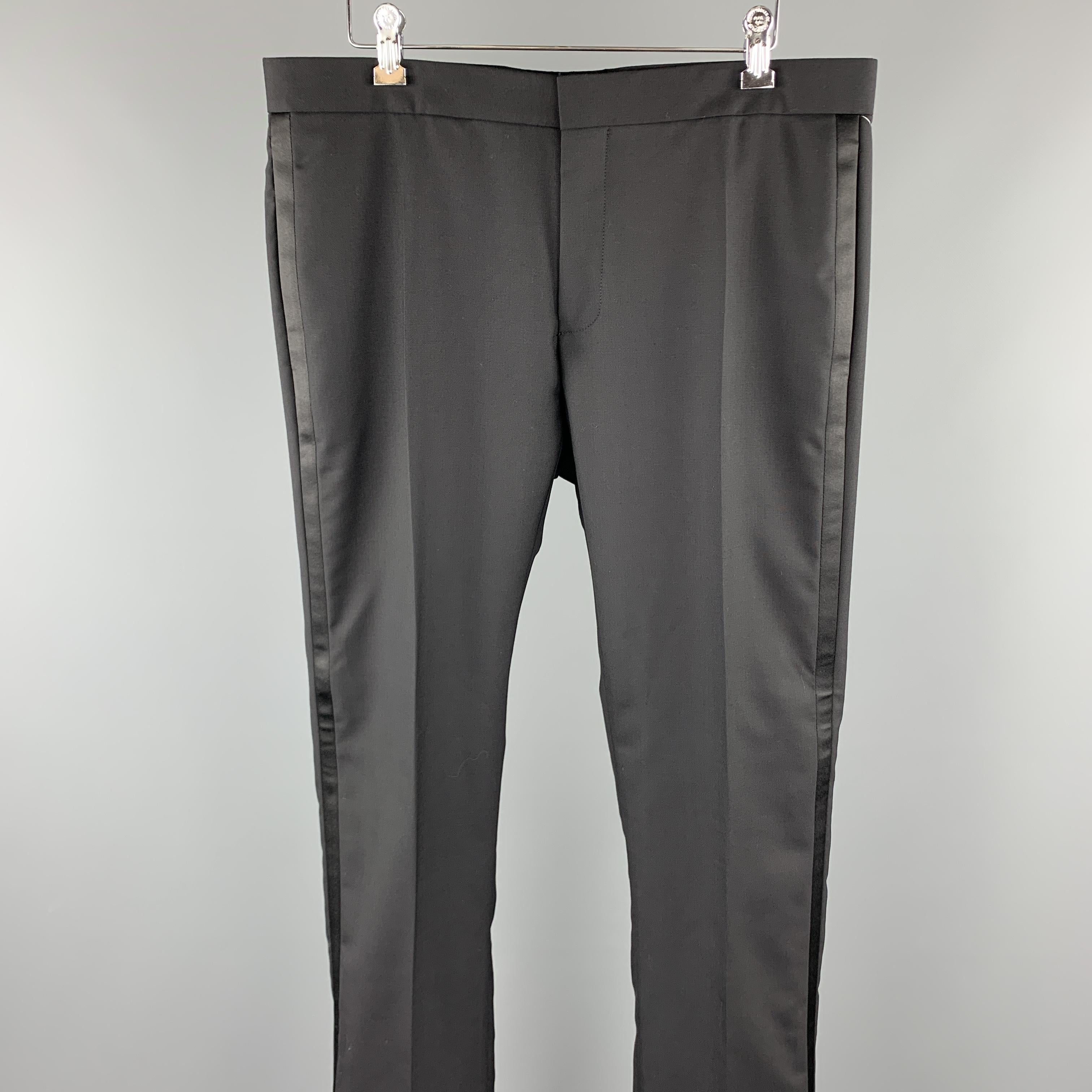 DIOR HOMME tuxedo dress pants comes in a black wool featuring a flat front style, front tab, and a zip fly closure. Made in Italy.

Excellent Pre-Owned Condition.
Marked: IT 50

Measurements:

Waist: 34 in. 
Rise: 8.5 in. 
Inseam: 33 in. 