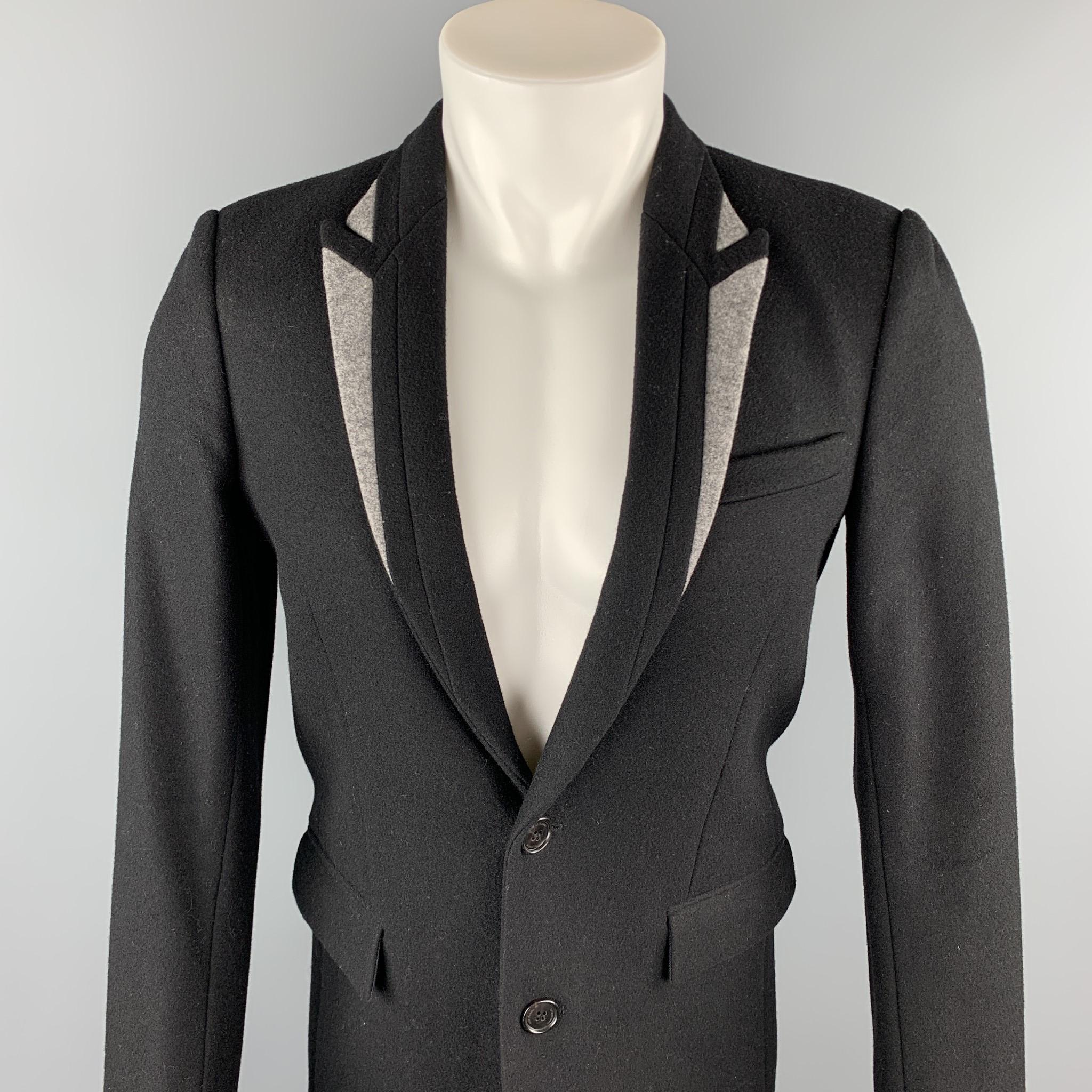 DIOR HOMME coat comes in a black & gray wool / polyamide featuring a peak lapel, flap pockets, and a two button closure. Made in Italy.

Very Good Pre-Owned Condition.
Marked:  IT 46

Measurements:

Shoulder: 16.5  in. 
Chest: 37 in. 
Sleeve: 26 in.
