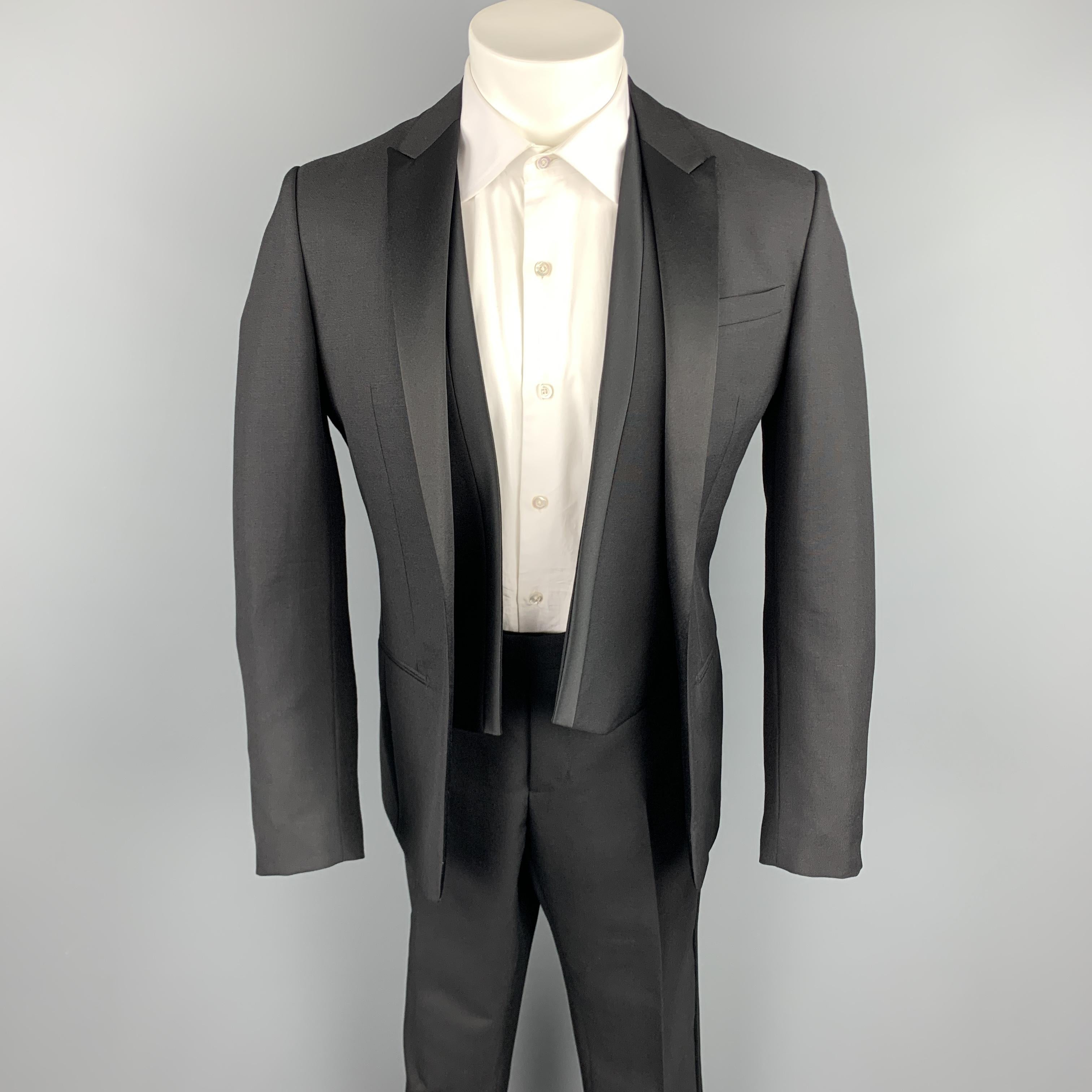 DIOR HOMME 3 Piece Tuxedo suit comes in a black wool / mohair and includes a open front sport coat with peak lapel and matching flat front trousers. Professional tailoring on suit read measurements. Made in Italy.

Excellent Pre-Owned