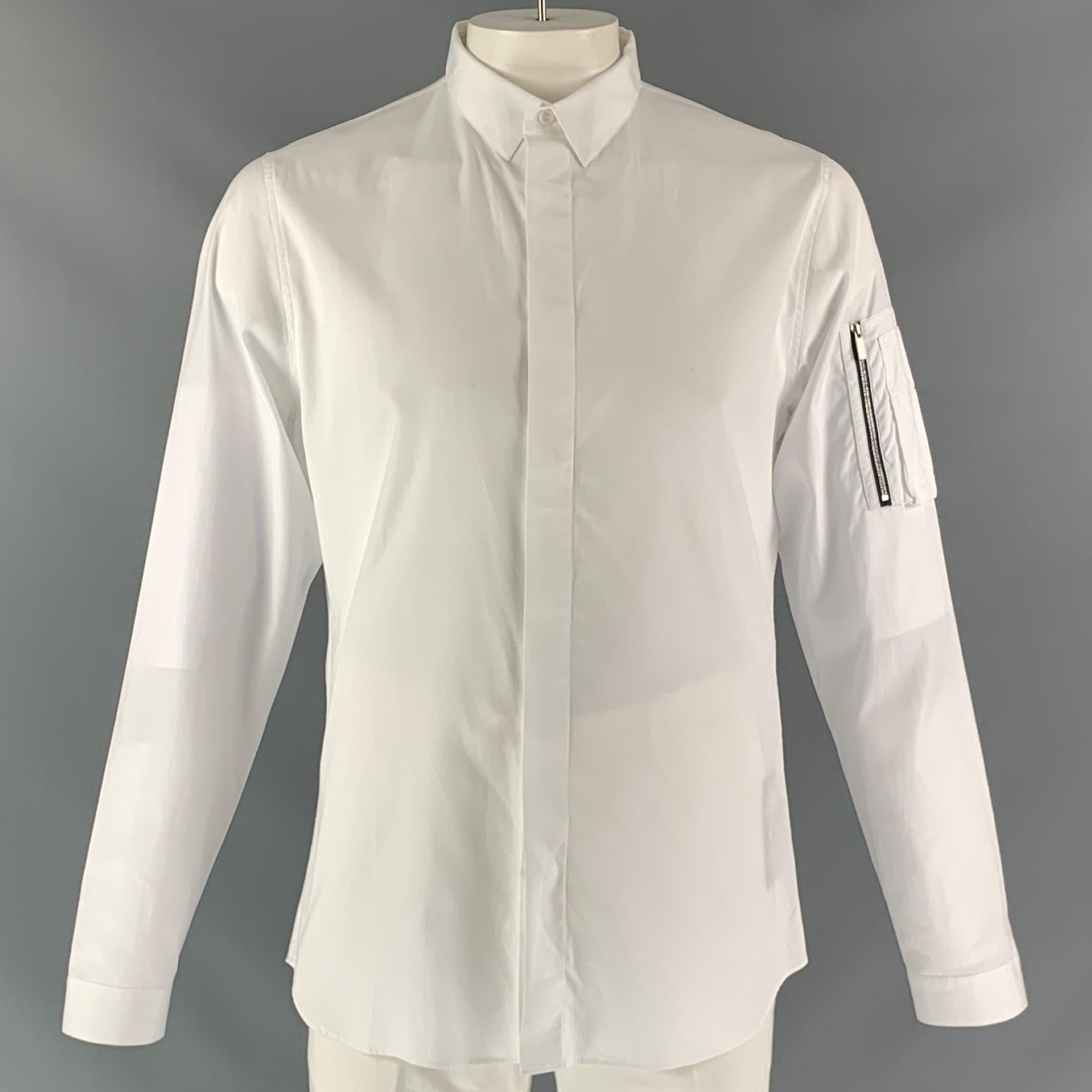 DIOR HOMME long sleeve dress shirt comes in white cotton fabric, button up closure, straight collar, removable collar stays and two button square sleeve cuff features arm pockets. Made in Italy.

Excellent Pre-Owned Condition.
Marked: