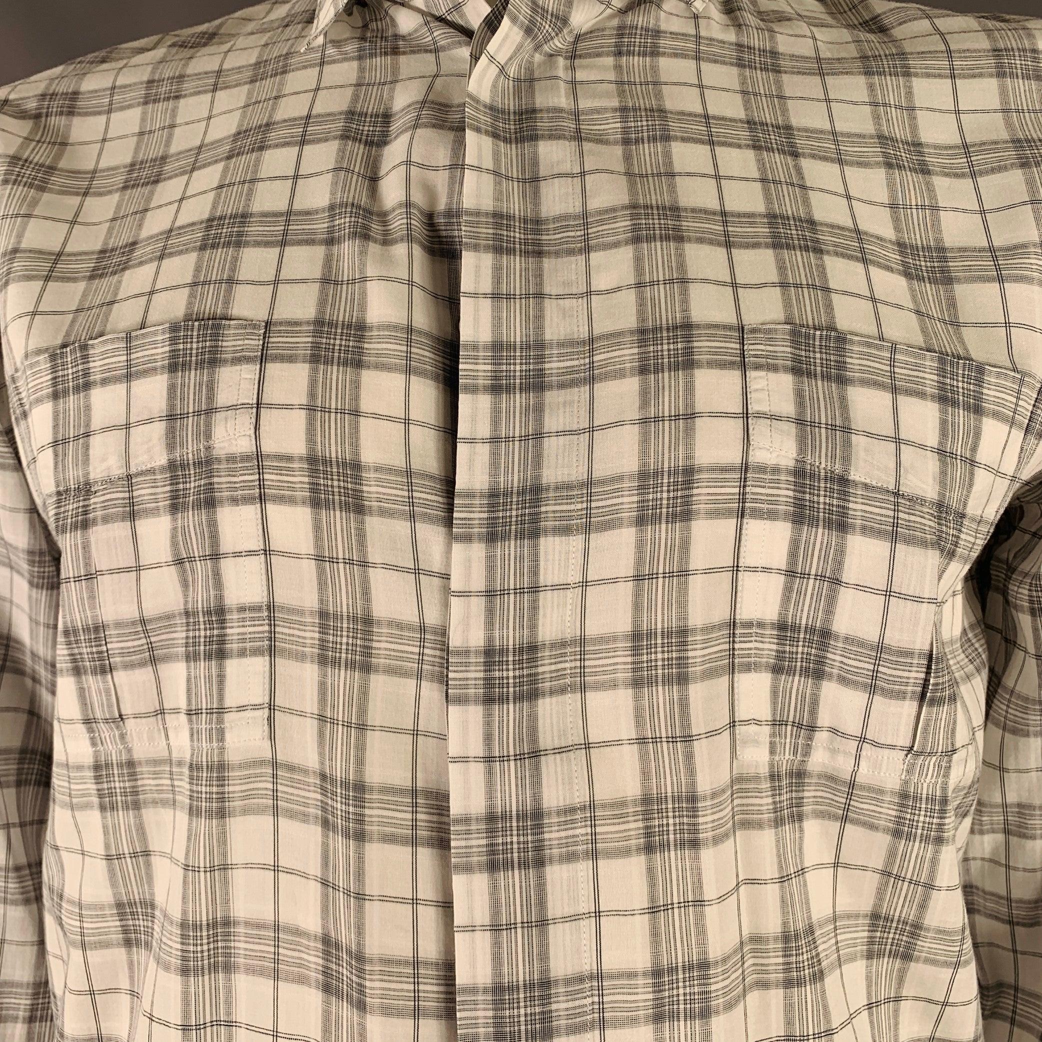 DIOR HOMME long sleeve shirt
in a white and grey cotton woven fabric featuring a plaid pattern, two chest pockets, and hidden button closure. Made in Italy.Excellent Pre-Owned Condition. 

Marked:   42 

Measurements: 
 
Shoulder: 18.5 inches Chest: