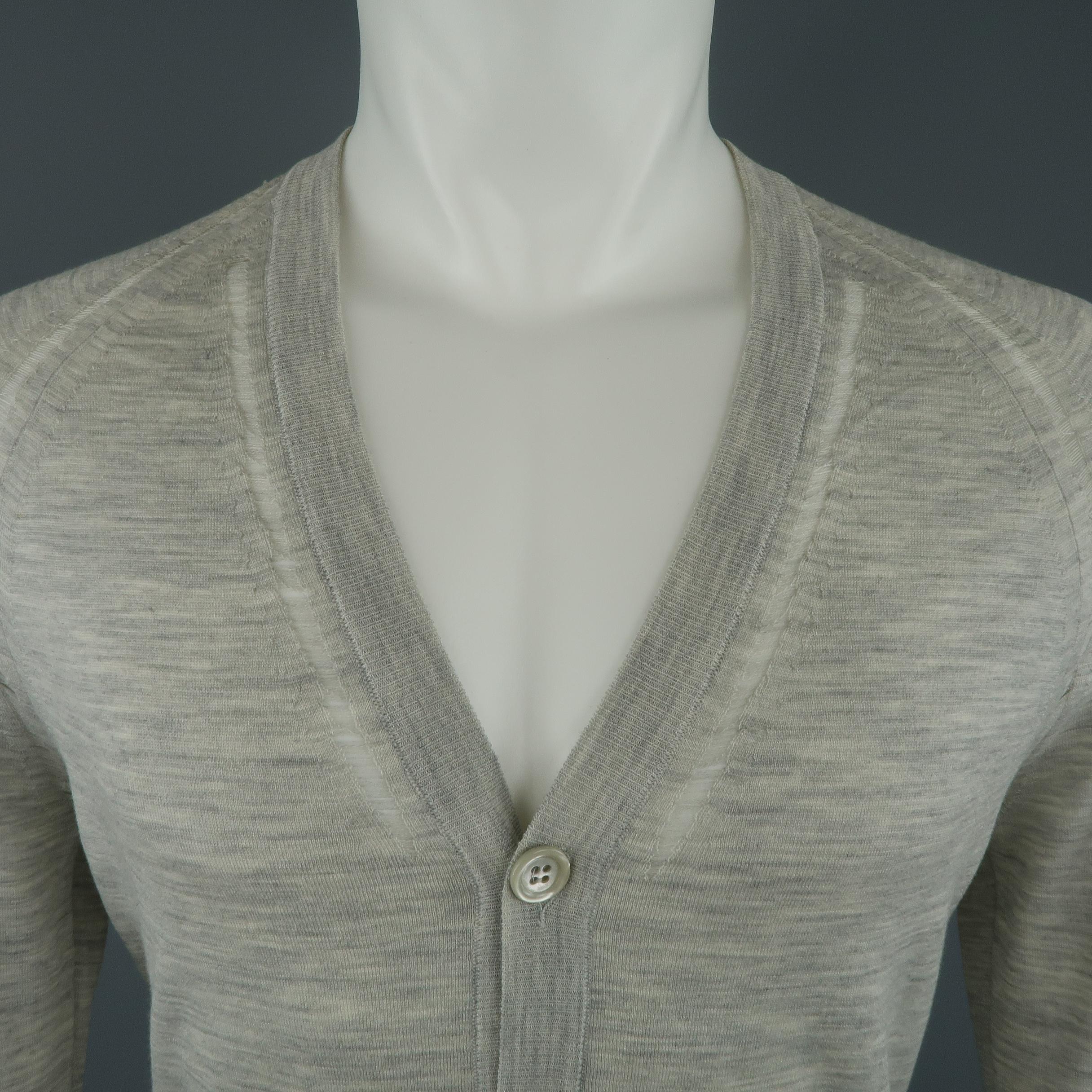DIOR HOMME cardigan comes in light heather gray wool knit with a V neck, button up front, pockets, and distressed shredded run trim details. Faint discolorations on cuffs. As-is. Made in Italy.
 
Good Pre-Owned Condition.
Marked: S
 
Measurements:
