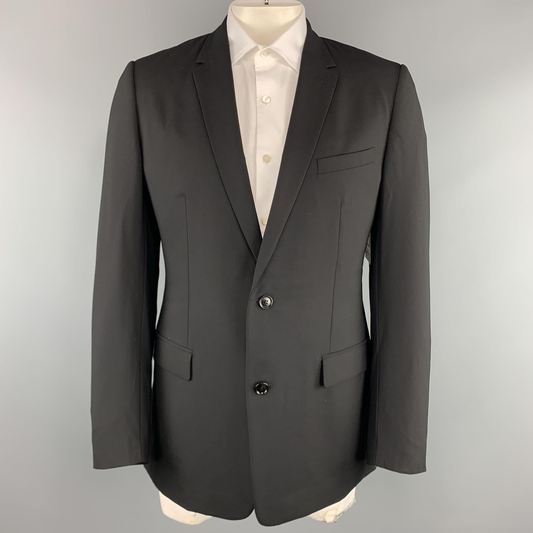 DIOR HOMME suit comes in black virgin wool and includes a single breasted, two button sport coat with a notch lapel and matching flat front trousers. Made in Italy.

Excellent Pre-Owned Condition.
Marked: IT 54 R

Measurements:

-Jacket
Shoulder: 17