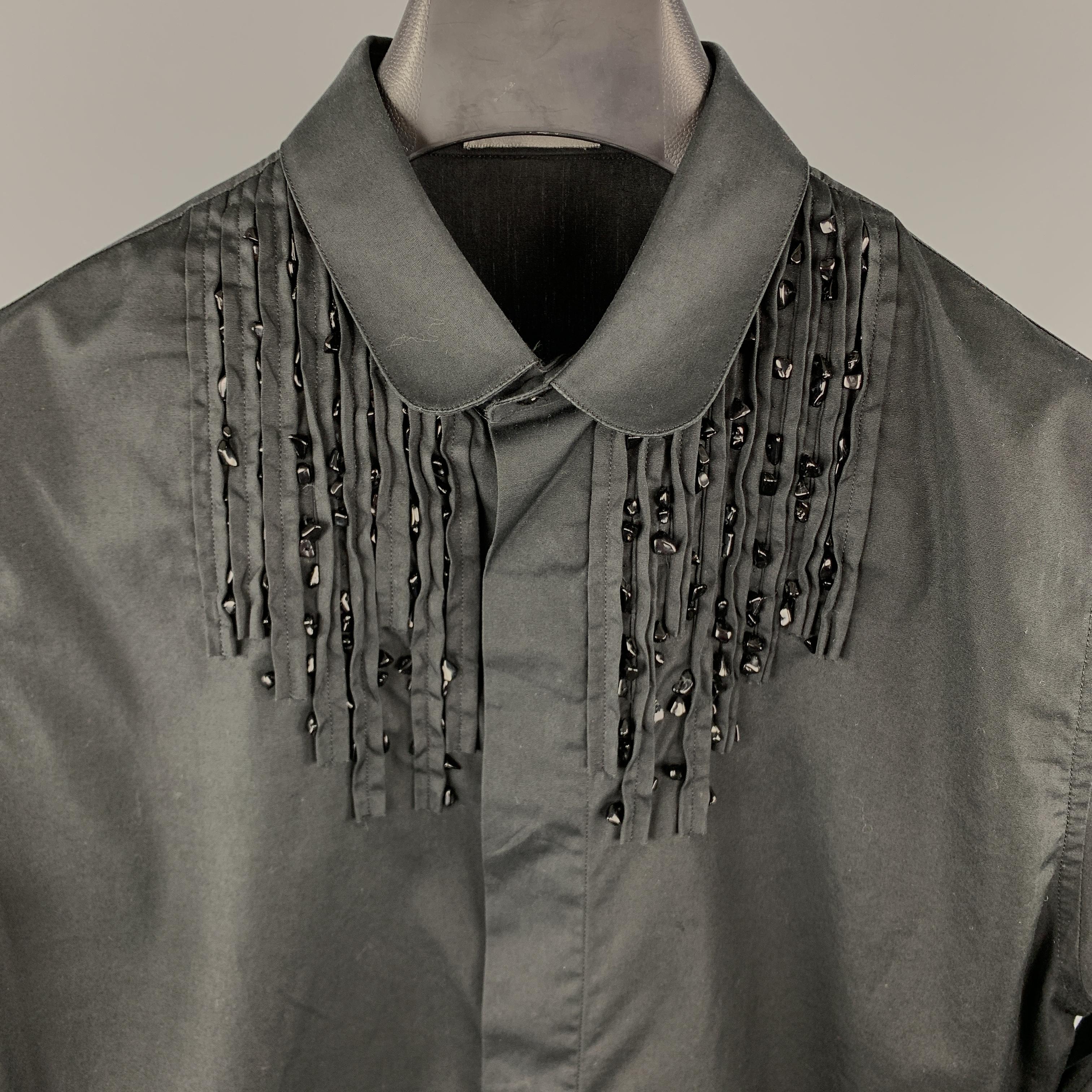 DIOR HOMME Long Sleeve Shirt comes in a black tone in a solid cotton material, with a rounded collar, beaded front, hidden buttons at closure, French cuffs, button up. Made in Italy.

Excellent Pre-Owned Condition.
Marked: