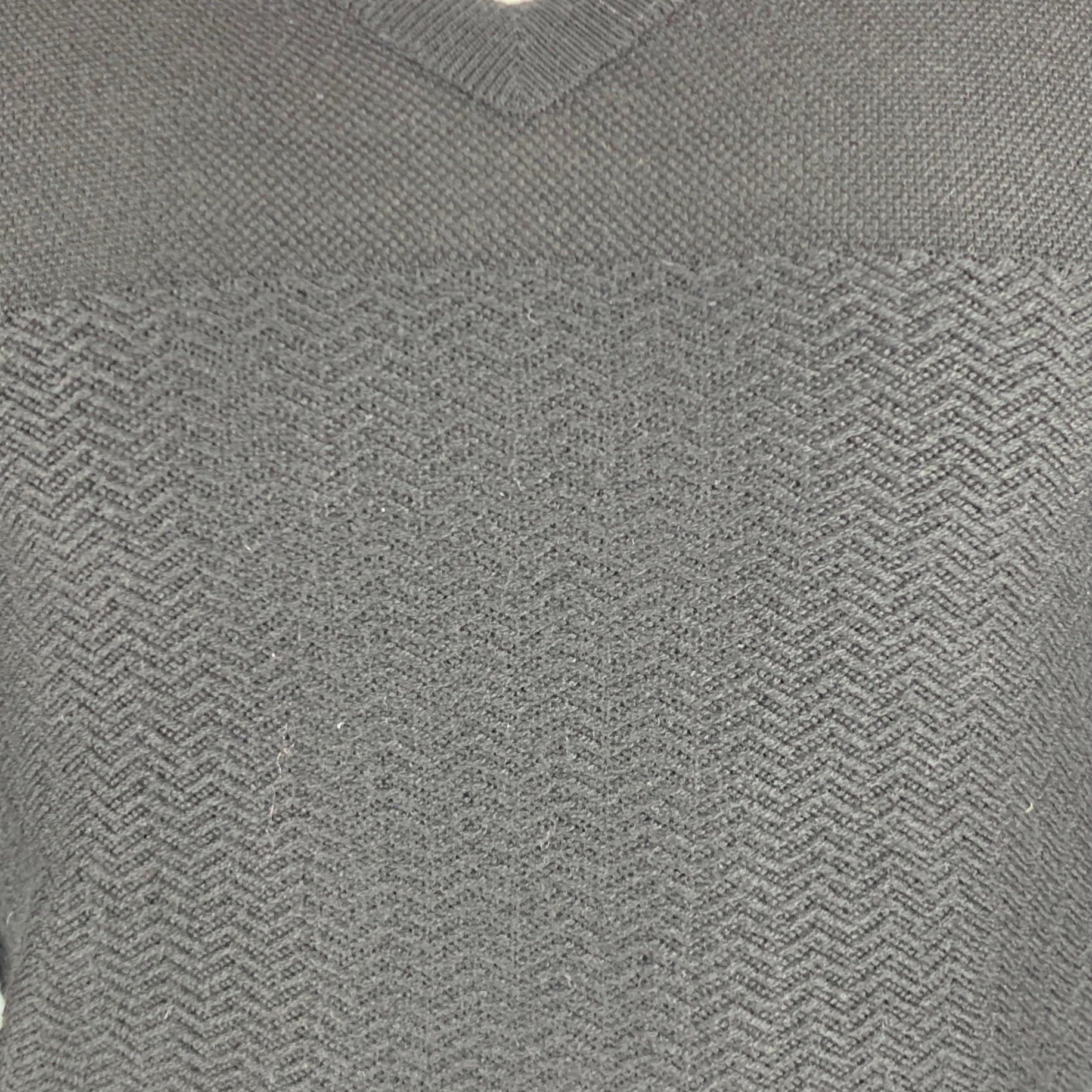 DIOR HOMME pullover
in a black virgin wool knit featuring contrasting knit techniques, blouson sleeves, and V-neck. Made in Italy.Very Good Pre-Owned Condition. Minor mark, and holes on left cuff. 

Marked:   XS 

Measurements: 
 
Shoulder: 16