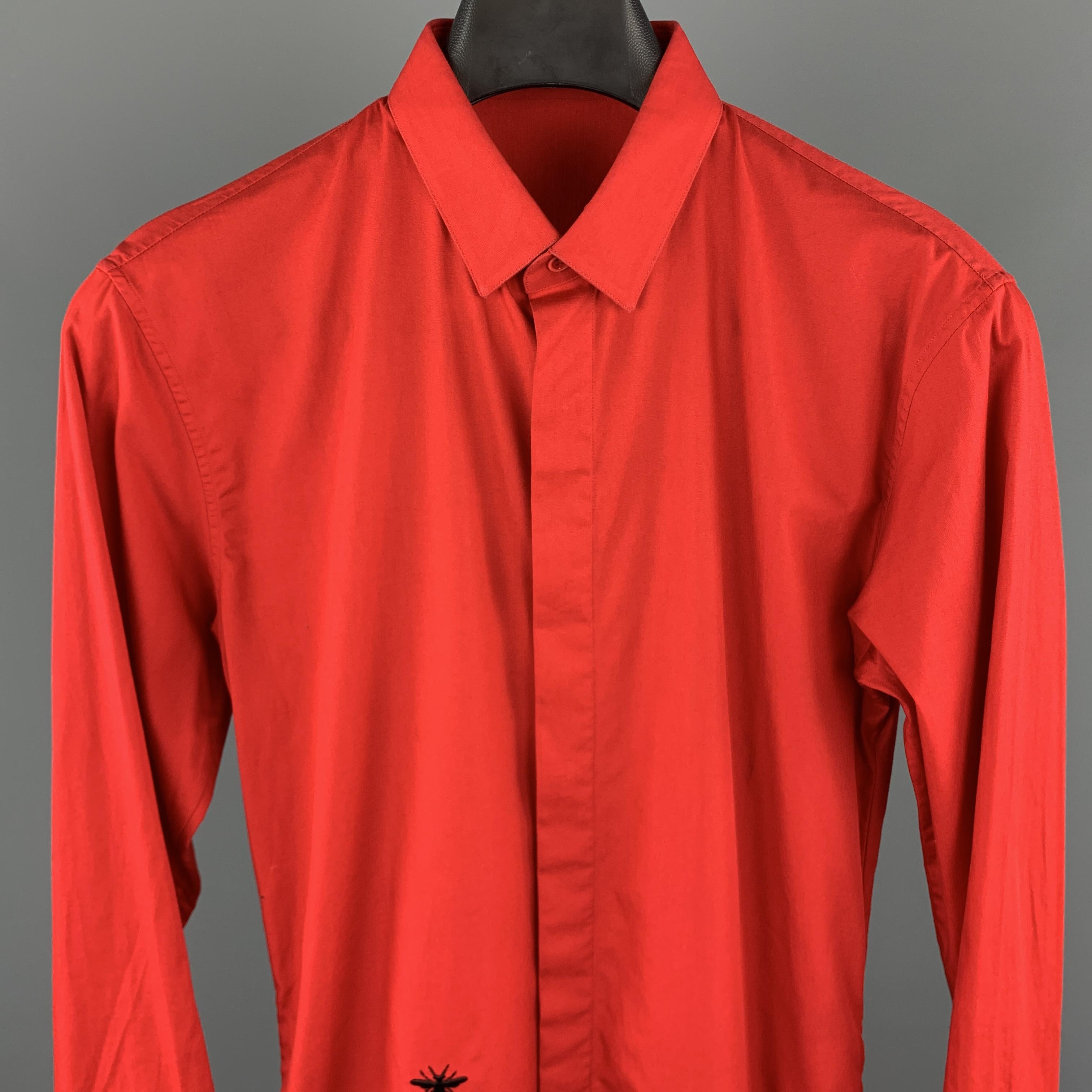 DIOR HOMME Long Sleeve Shirt comes in a red tone in a solid cotton material, with a narrow collar, hidden buttons at closure, a bee embroidered at front, buttoned cuffs, button up. Made in Italy.

Excellent Pre-Owned Condition.
Marked: No size 