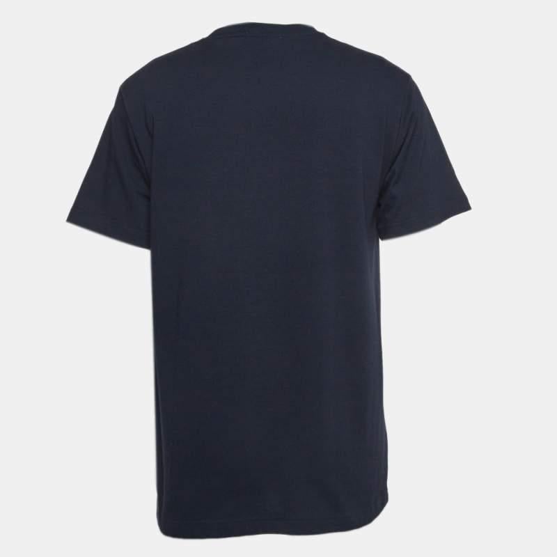 The Dior Homme X Air Jordan t-shirt seamlessly blends luxury and sportswear. Crafted from premium cotton, it features intricate embroidery, fusing Dior's sophistication with Air Jordan's athletic edge. The navy hue adds a touch of timeless style to