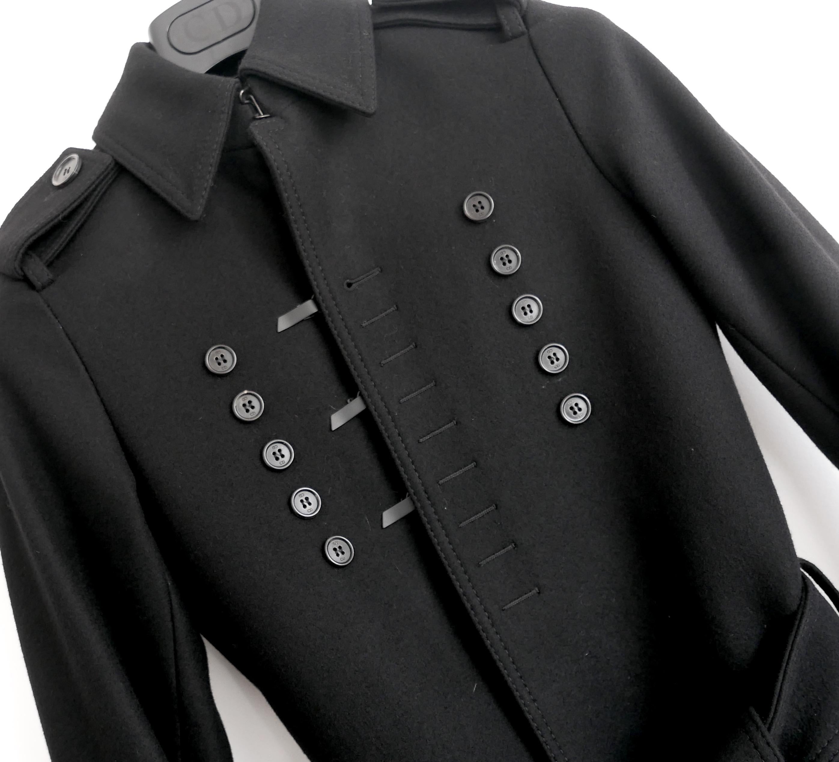 Ultra rare archival Dior Homme trench coat from Hedi Slimane’s Fall 2006 Collection. Worn a couple of times and then carefully stored. Comes with CD hanger. Made from thick black wool with a black twill and striped sleeve lining. It has a sleek