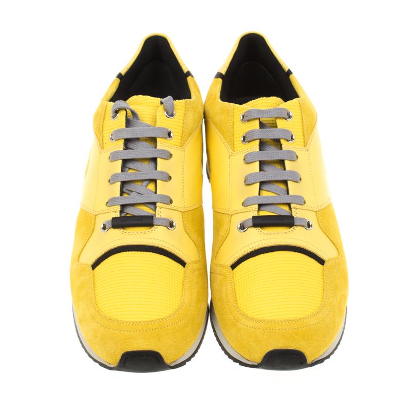The clean-cut look in these sneakers is created with a yellow exterior, crafted from a combination of suede, leather and fabric, in an amazing fashion. The contrastingly-colored laces feature engraved Dior Homme plaques. Equipped with leather-lined