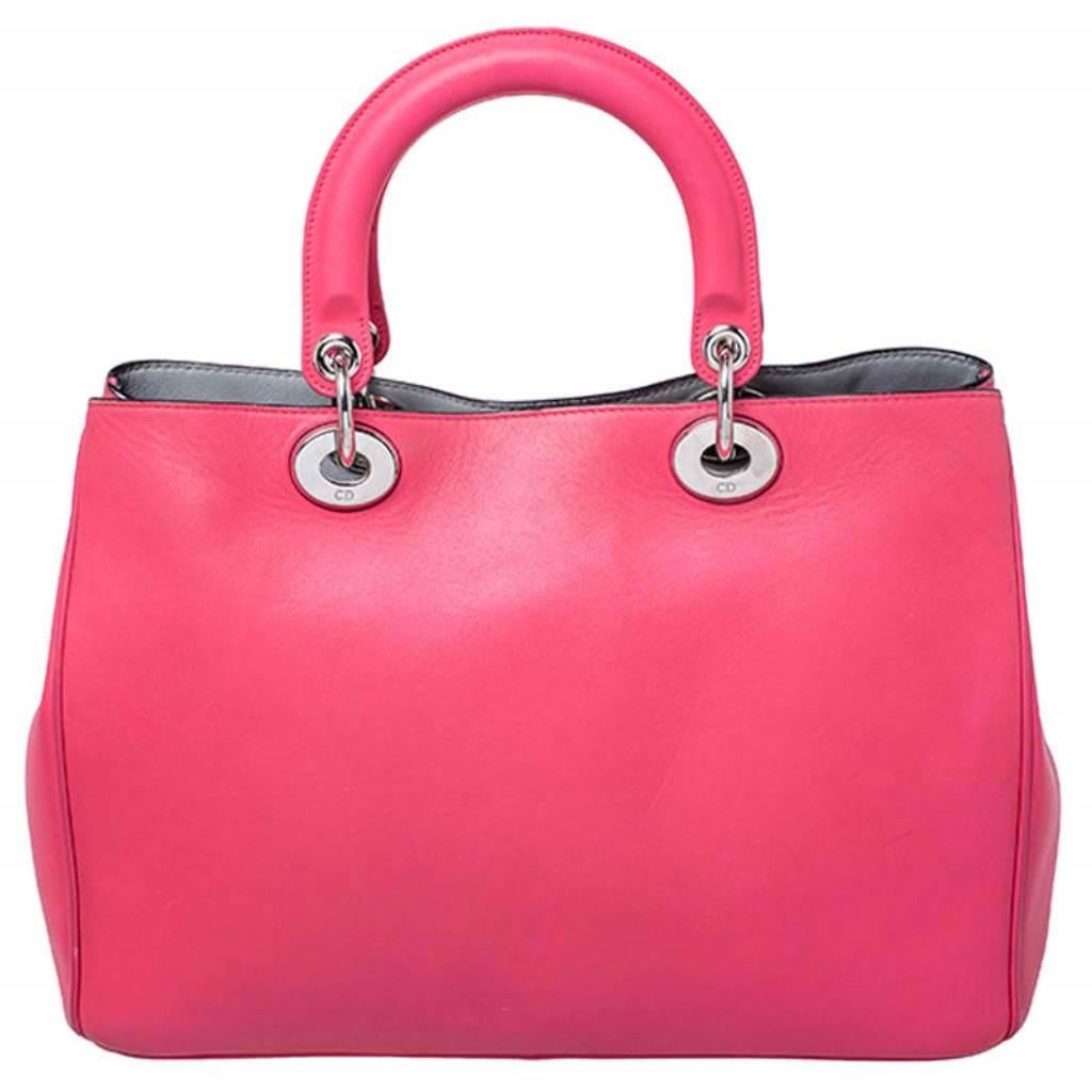 The Diorissimo shopper tote from Dior is a piece that has never gone out of style. The leather bag comes in a pleasing pink shade with silver-tone hardware and Dior letter charms. It features double top handles, a small pouch and protective feet at