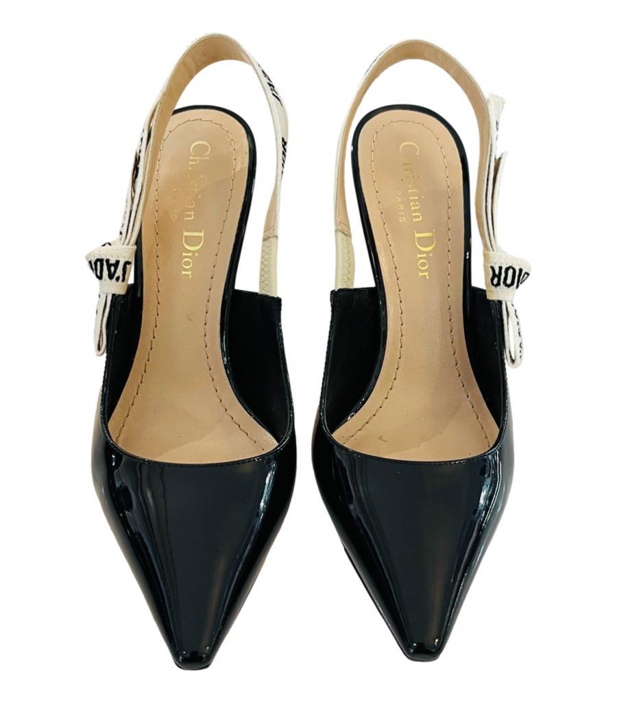 Dior J'Adior Patent Leather Slingback Pumps
Black heels designed with  J'Adior embroidered ribbon is embellished with a flat bow to the side.
Detailed with pointed toe, 10cm heel and leather soles. Rrp £850
Size – 35.5
Condition – Very Good (Some