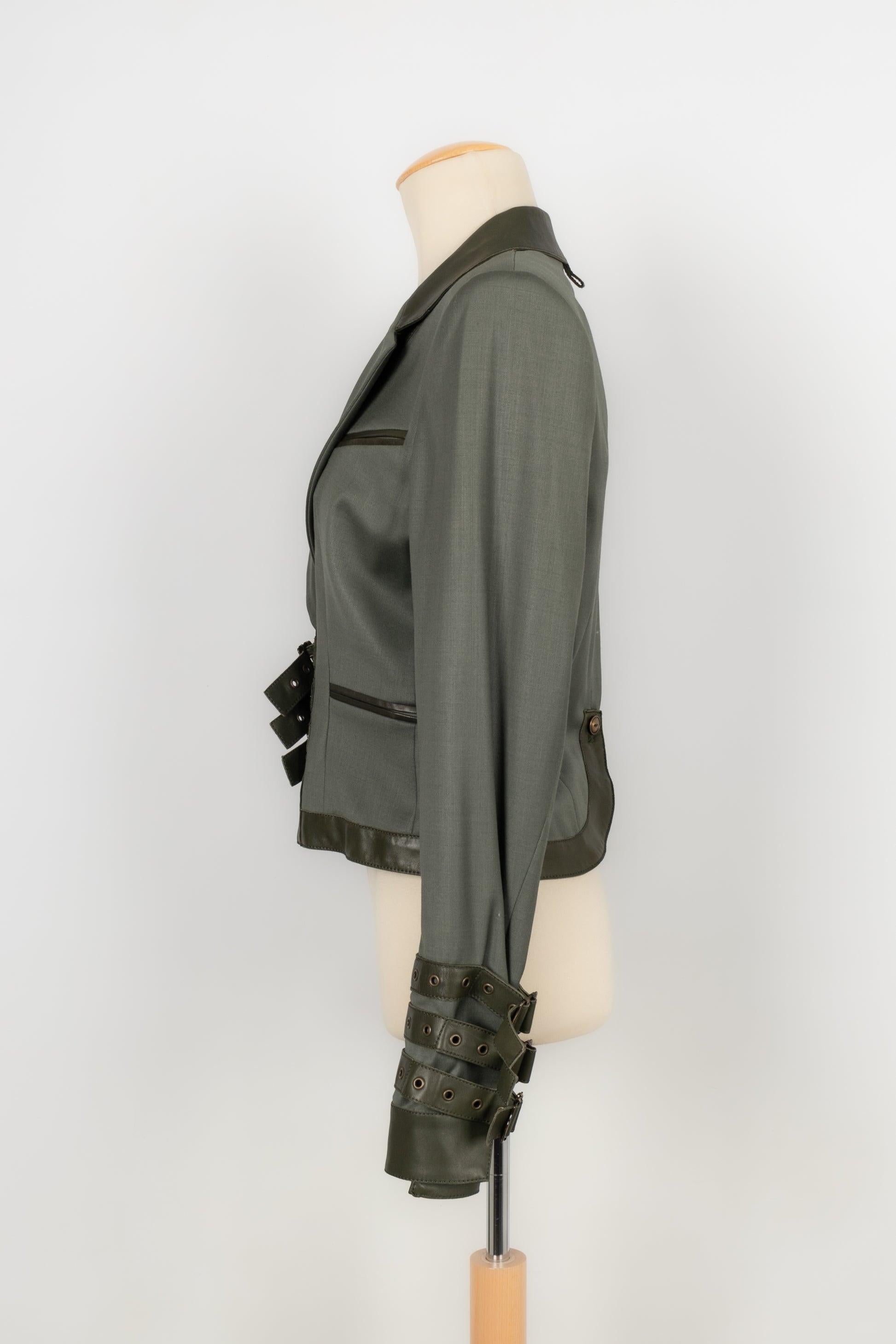 Dior - (Made in France) Olive green leather and wool jacket. The waist and the sleeve bottom are enhanced with buckles. Size 38FR. Fall-Winter 2003 Collection under the artistic direction of John Galliano.

Additional information:
Condition: Very