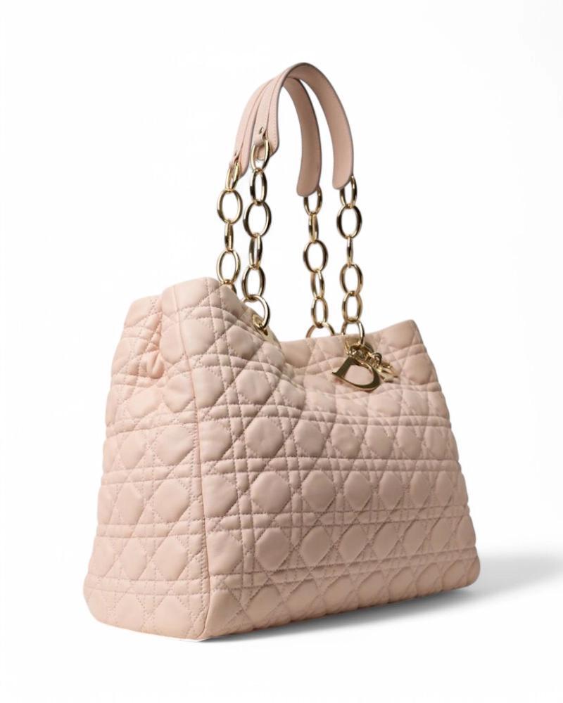 Dior signature bag, Lady Soft model in large size, made of pink leather with cannage pattern and gold hardware. Features a magnetic button top closure, tone-on-tone canvas-lined interior and has practical zippered and unzippered pockets. The bag is