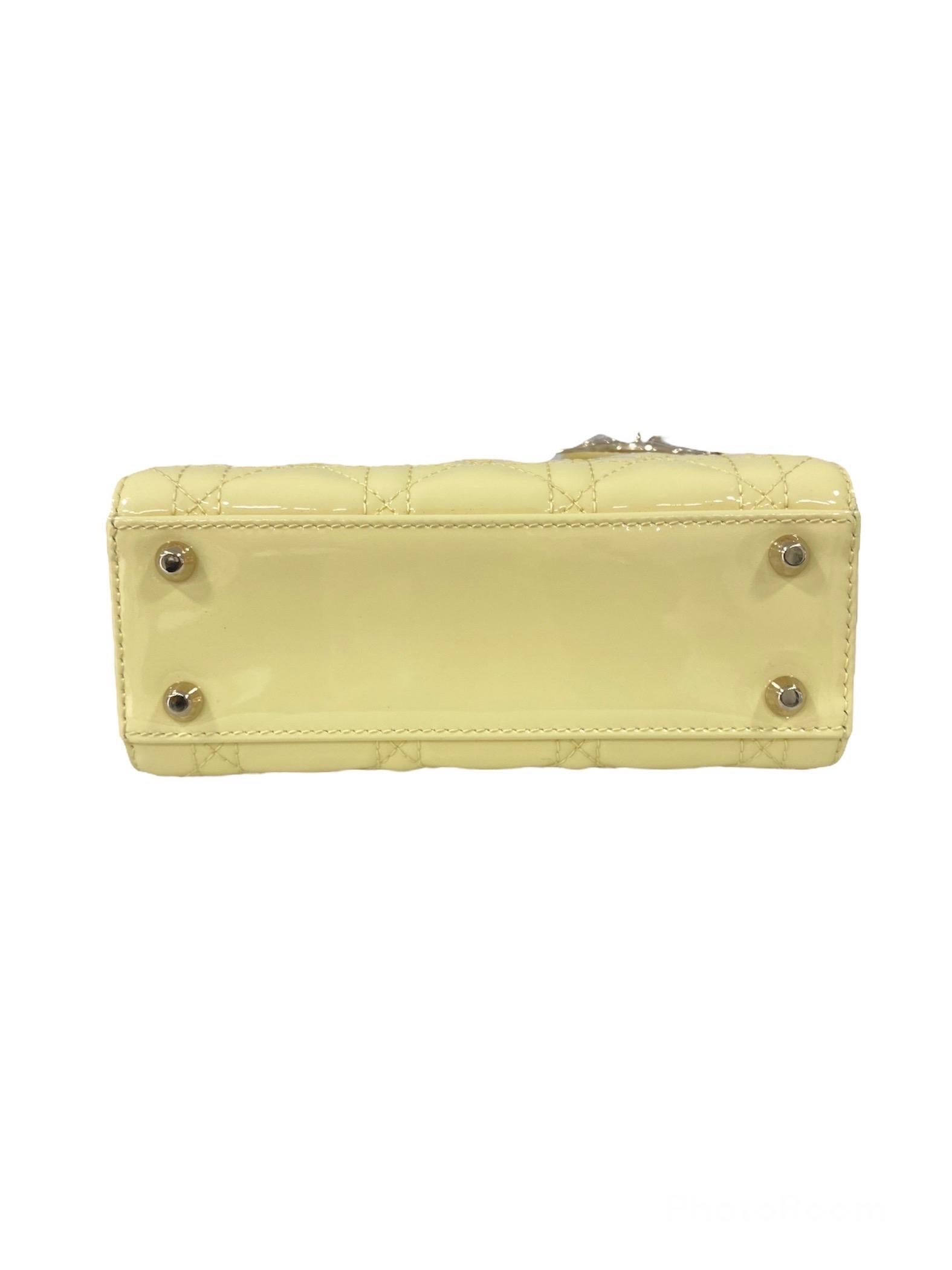 Dior designer bag, Lady model, small size, made of yellow patent leather with silver hardware.

Equipped with a flap closure, internally lined in yellow suede, roomy for the essentials.

Equipped with a double rigid handle in patent leather and a