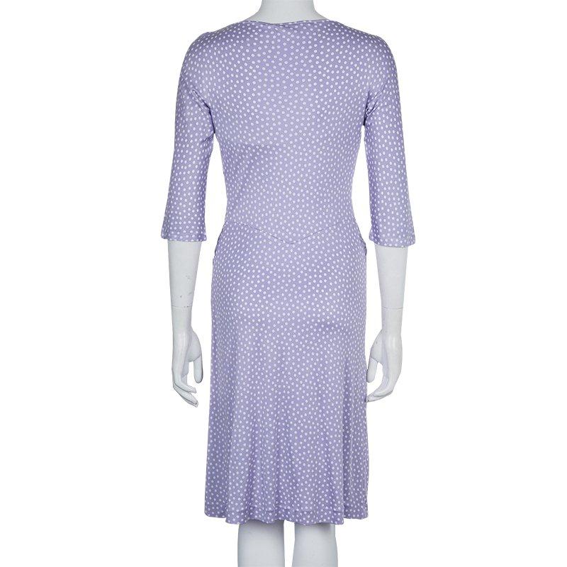 Dior dress in lavender is exemplary of simplistic elegance in style. The polka dot dress in natural silk is tailored in a fitted silhouette with a gathered design draped on the waistline. The long sleeves, knee length dress is finely hemmed over the