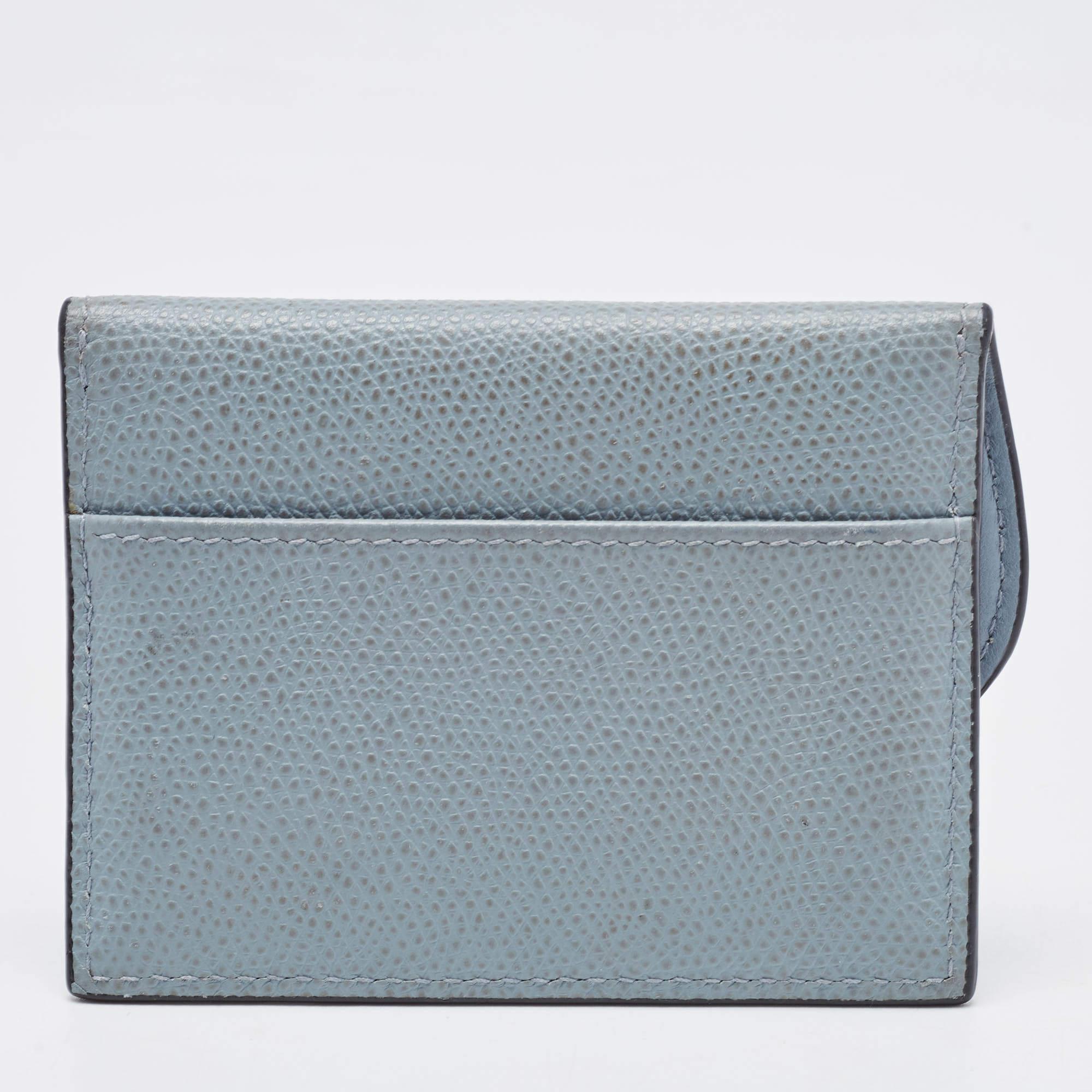 Crafted from leather in a light blue shade, the Dior card case comes with multiple compartments secured by a flap taken from the iconic Saddle bag. The creation is finished off with the D charm on the front.

Includes: Original Dustbag

