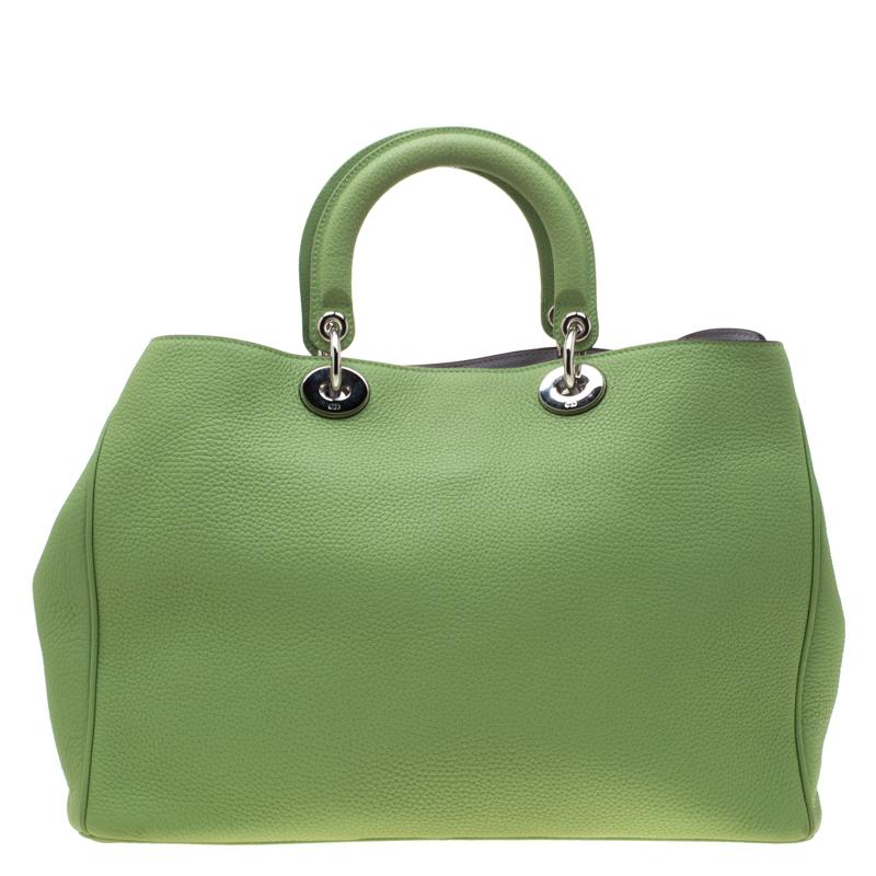 The Diorissimo tote from Dior is a timeless piece. The leather bag comes in a luxurious light green hue with silver-tone hardware and Dior letter charms. It features double top handles, a detachable shoulder strap and protective feet at the bottom.