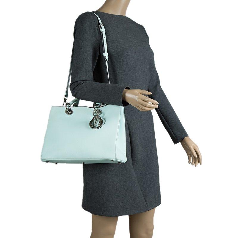 The Diorissimo bag from Dior is a timeless piece. The bag comes in light mint color, silver-tone hardware and a Dior charm. It features double top handles, removable shoulder strap that can be adjusted to the desired length and bottom protective