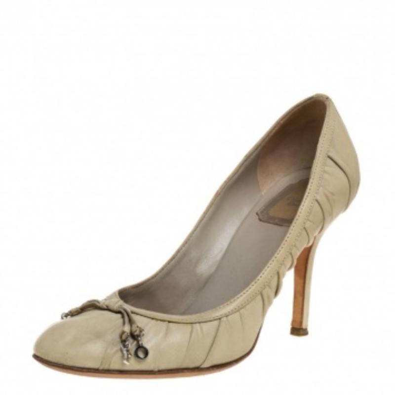 Classy and stylish, these pumps from Dior are truly worth the buy. They are crafted from olive green leather and styled with round toes and 'DIOR' letter detailed delicate bows on the uppers. They are endowed with comfortable insoles and elevated on