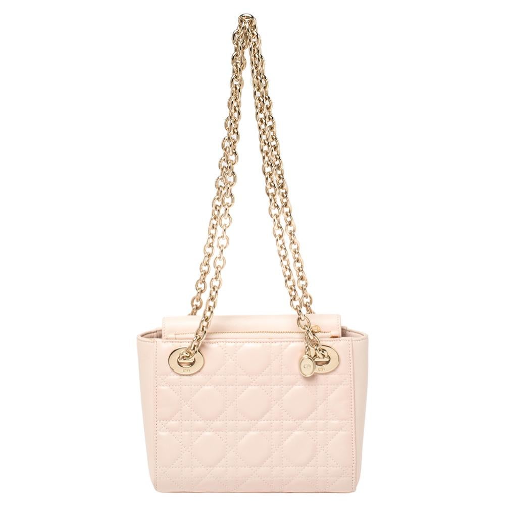 The iconic Lady Dior with double chains—what an update! Crafted using leather in its famous silhouette and Cannage design, the Lady Dior tote is transformed into a shoulder bag thanks to two gold-tone chains. It is lined with nylon and finished with