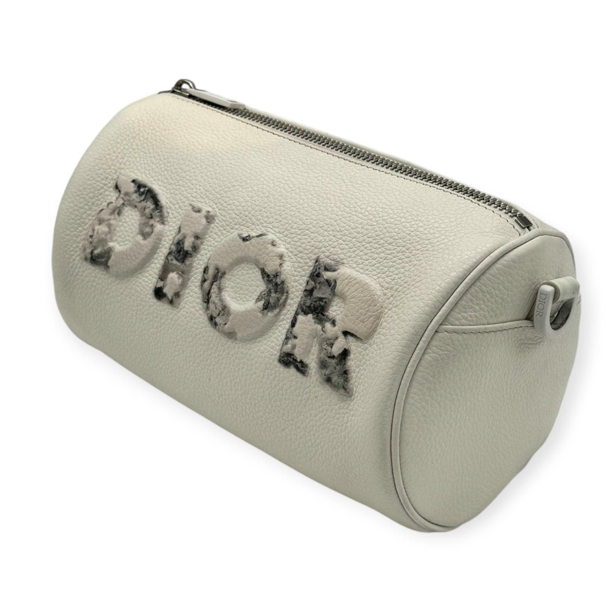 Introducing the Dior Limited Edition White Bag—a stunning circular silhouette with an elegant white finish. Adorned with delicate ink wash print over the iconic Dior logo, it exudes artistic charm. Comes with an interior shoulder strap for versatile