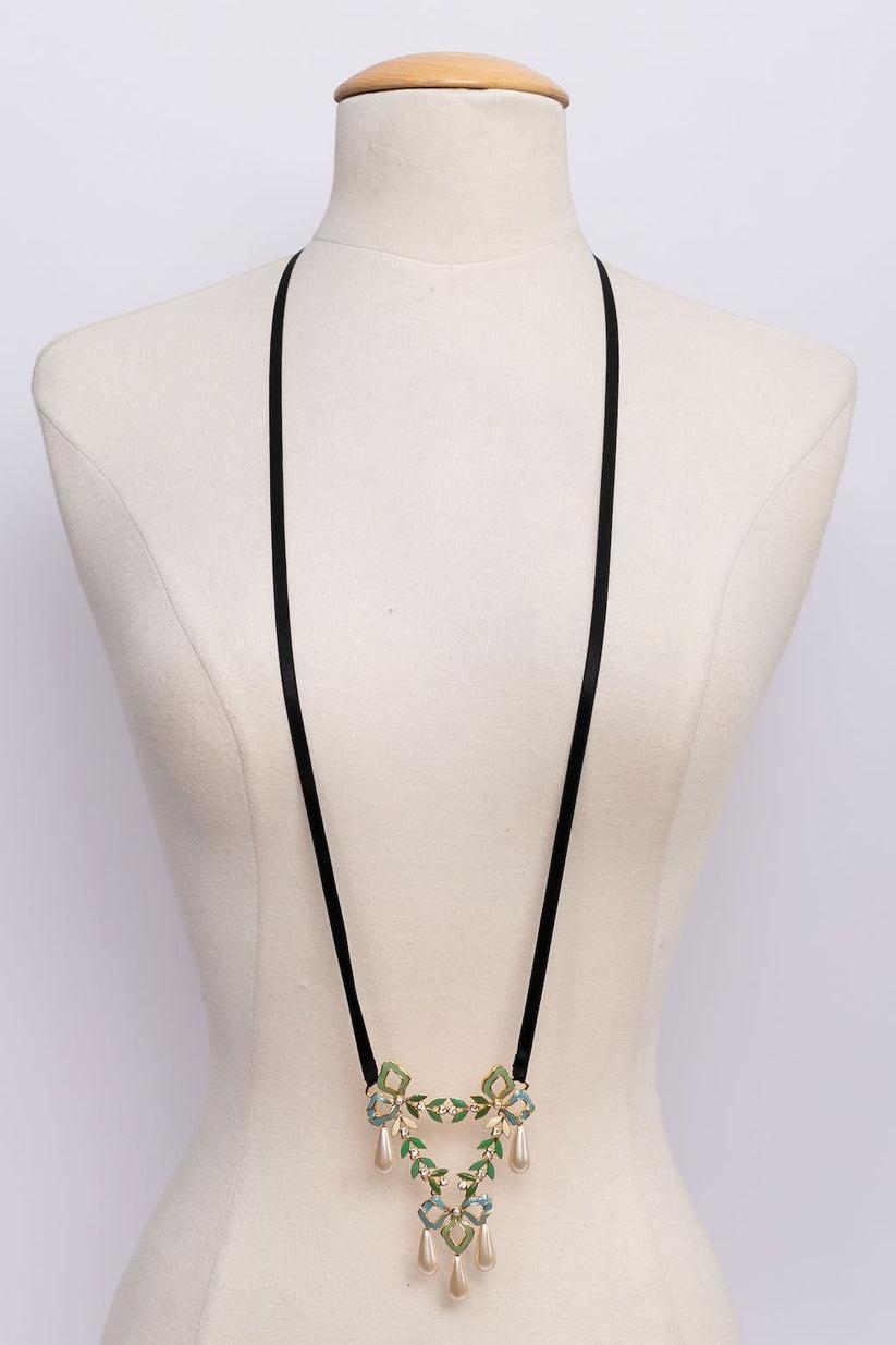 Dior - Long necklace made of a black silk ribbon hanging a gilted metal enamelled pendant.

Additional information: 

Dimensions: 
Length: 104 cm (40.94 in) to 108 cm (42.52 in), Pendant: 7 cm (2.76 in) x 9 cm (3.54 in) 

Condition: 
Very good