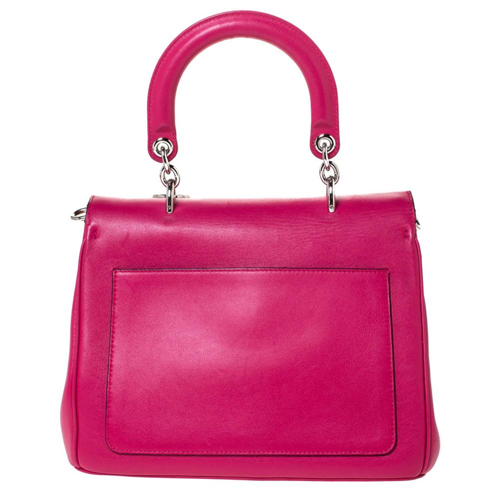 This Be Dior bag from the house of Dior is sure to add sparks of luxury to your wardrobe! It is crafted from leather and features a chic silhouette. It flaunts a single top handle with attached 'DIOR' letter charms and comes equipped with protective