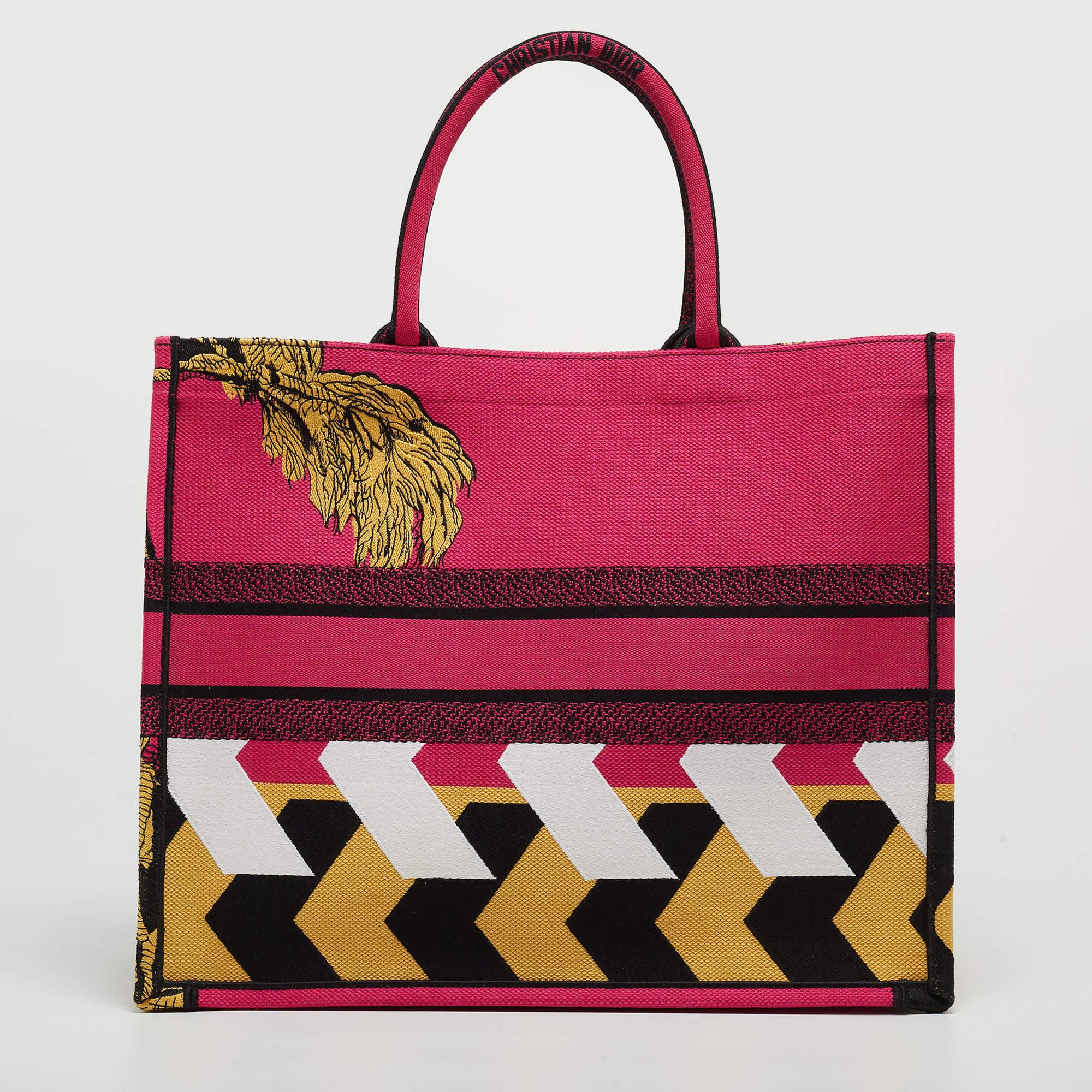 Designed by Maria Grazia Chiuri, the Dior Book Tote is a travel accessory for people with style. The bag here is crafted using canvas into a beautiful structure and covered in --- all over. Two handles, the 'Christian Dior' signature, and a spacious