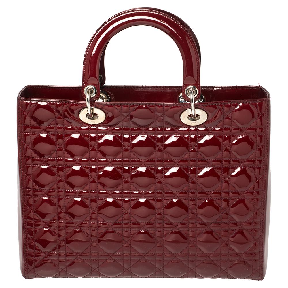 The Lady Dior tote is a Dior creation that has gained recognition worldwide and is today a coveted bag that every fashionista craves to possess. This maroon tote has been crafted from patent leather and it carries the signature Cannage quilt. It is