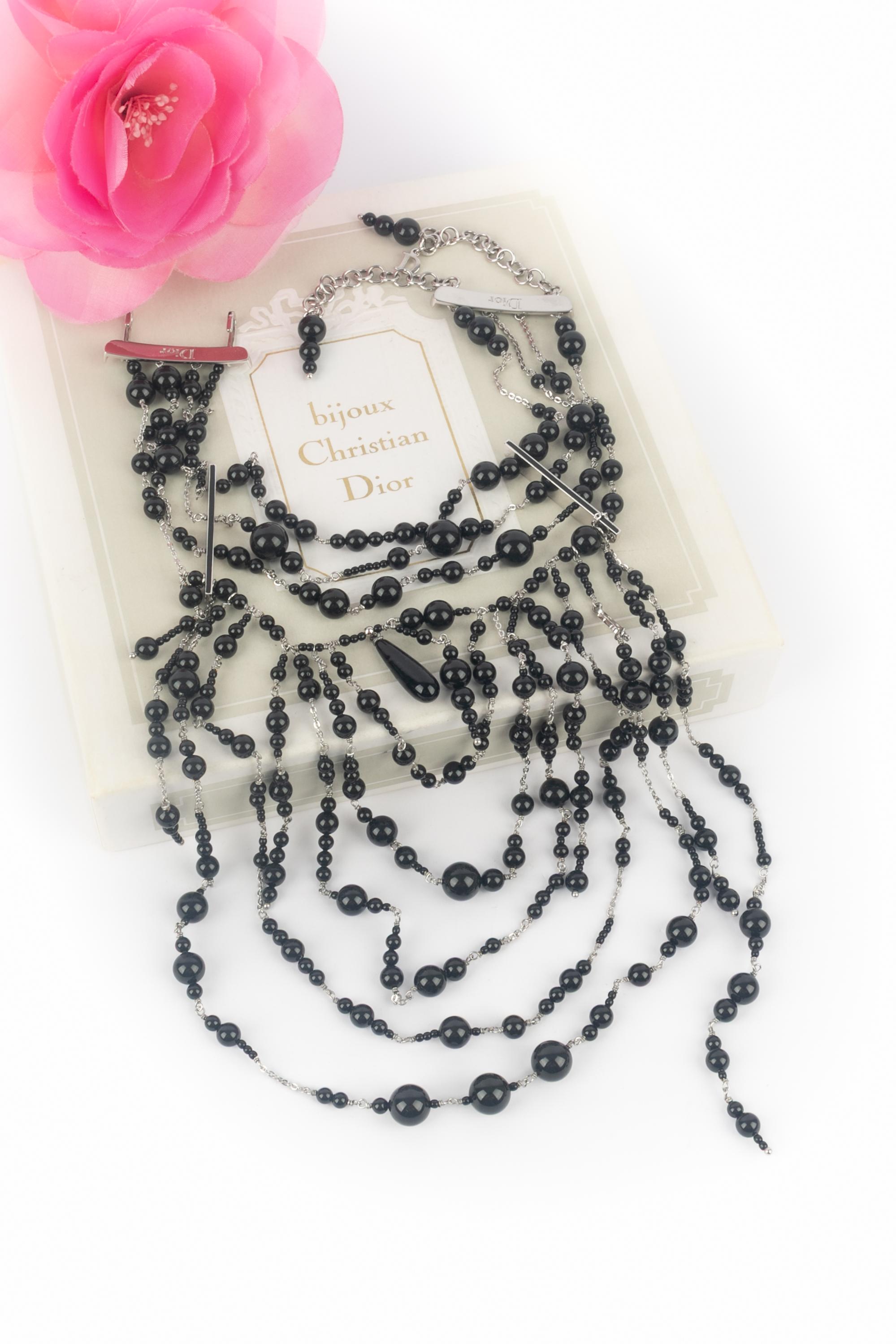 DIOR - (Made in France) Collana girocollo in metallo argentato con perle di vetro nere. Gioielli di una collezione Massai sotto la direzione artistica di John Galliano.

Condizioni:
Ottime condizioni

Dimensioni:
Lunghezza: da 28 a 35 cm

SKU:BC74