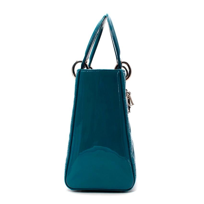 Dior Medium Teal Patent Leather Cannage Lady Dior Bag
 

 - Iconic Lady Dior top handle bag crafted from a bold teal-hued patent leather with signature cannage quilting all over
 - 2 patent coated flat top handles, attached with silver-tone metal