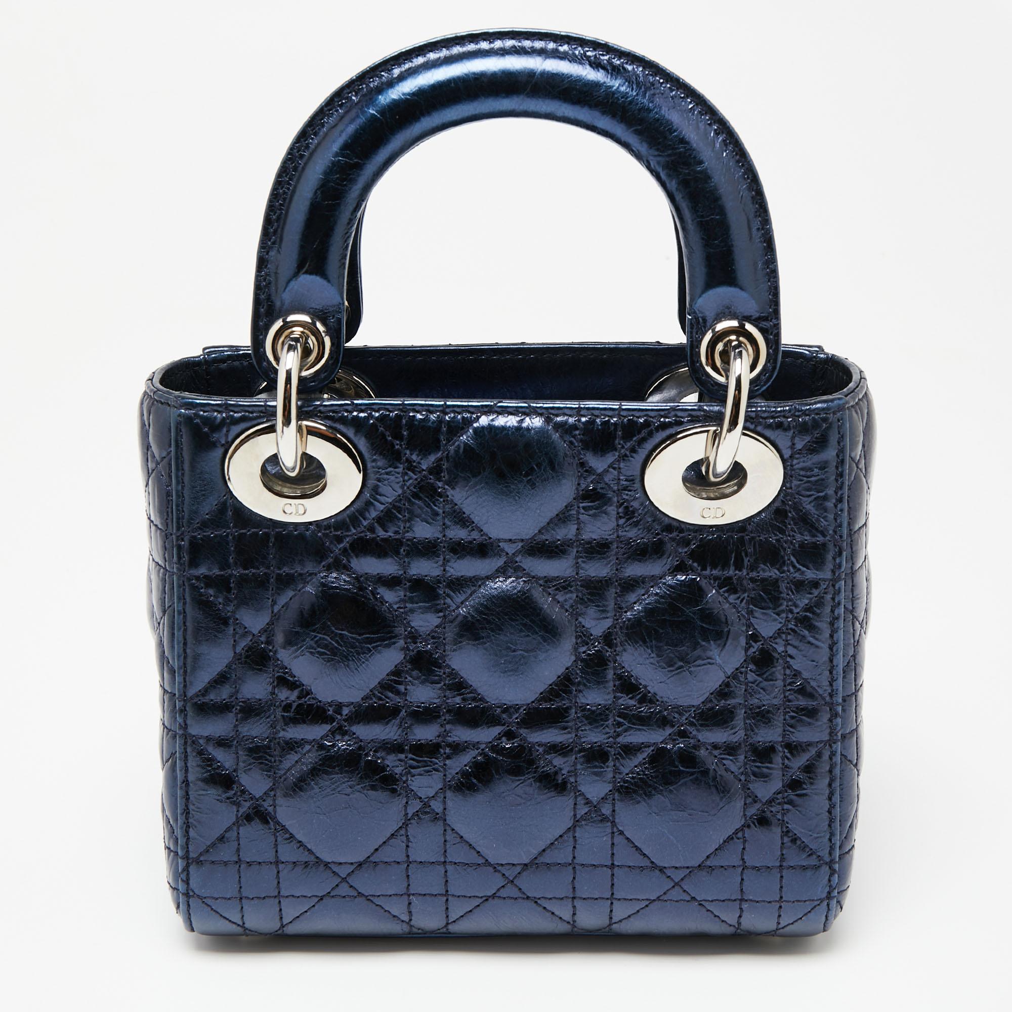 A timeless status and great design mark the Lady Dior tote. It is an iconic bag that people continue to invest in to this day. We have here this mini Lady Dior tote crafted from crinkled leather. The bag is complete with two top handles, a shoulder