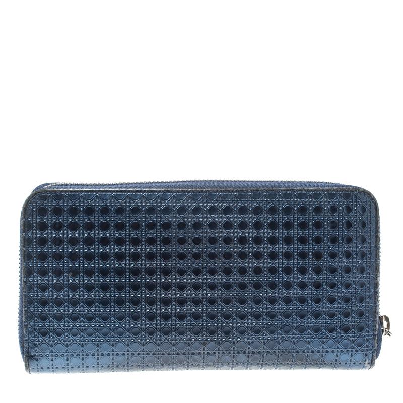 Luxe and classy, this zip around wallet is from Dior. It has been crafted from metallic blue patent leather, detailed with their signature Cannage pattern all over and equipped with a zipper leading to multiple slots and a zip pocket for you to