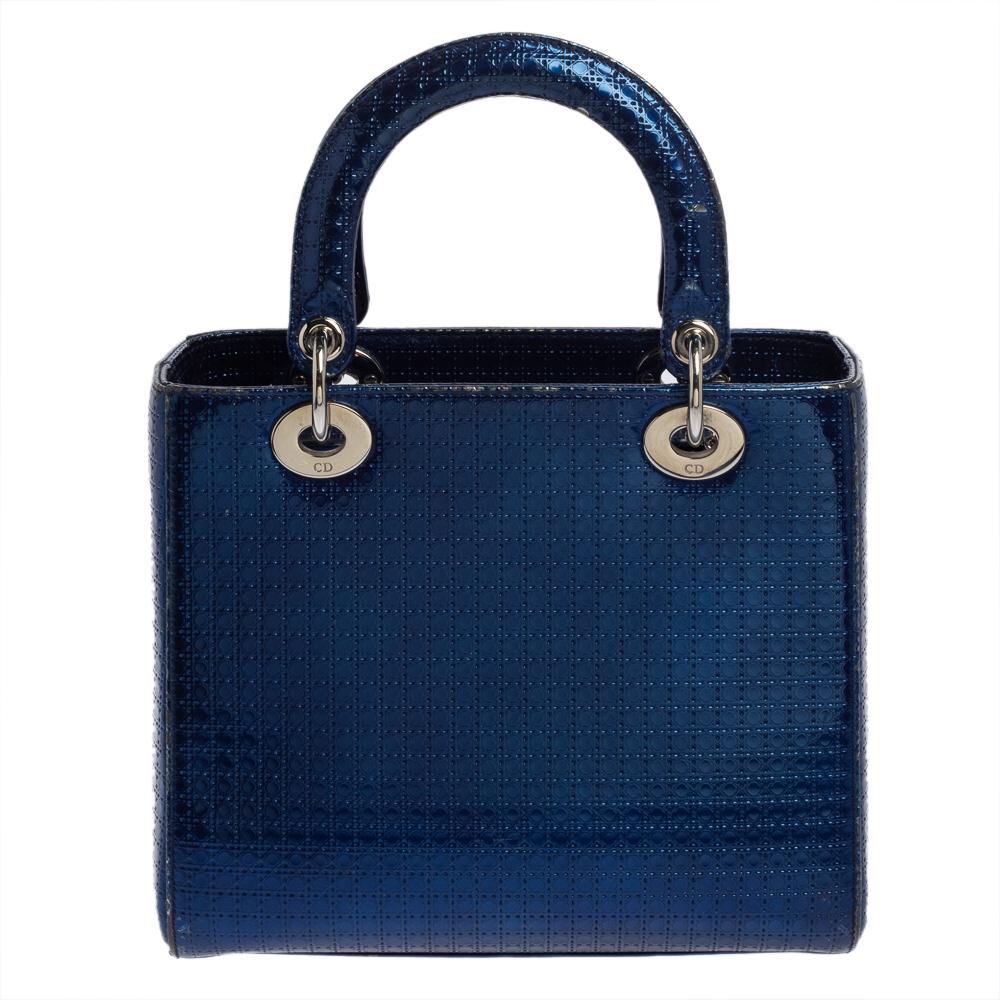 The Lady Dior tote is a Dior creation that has gained recognition worldwide and is today a coveted bag that every fashionista craves to possess. This metallic blue tote has been crafted from patent leather and it carries the signature Microcannage