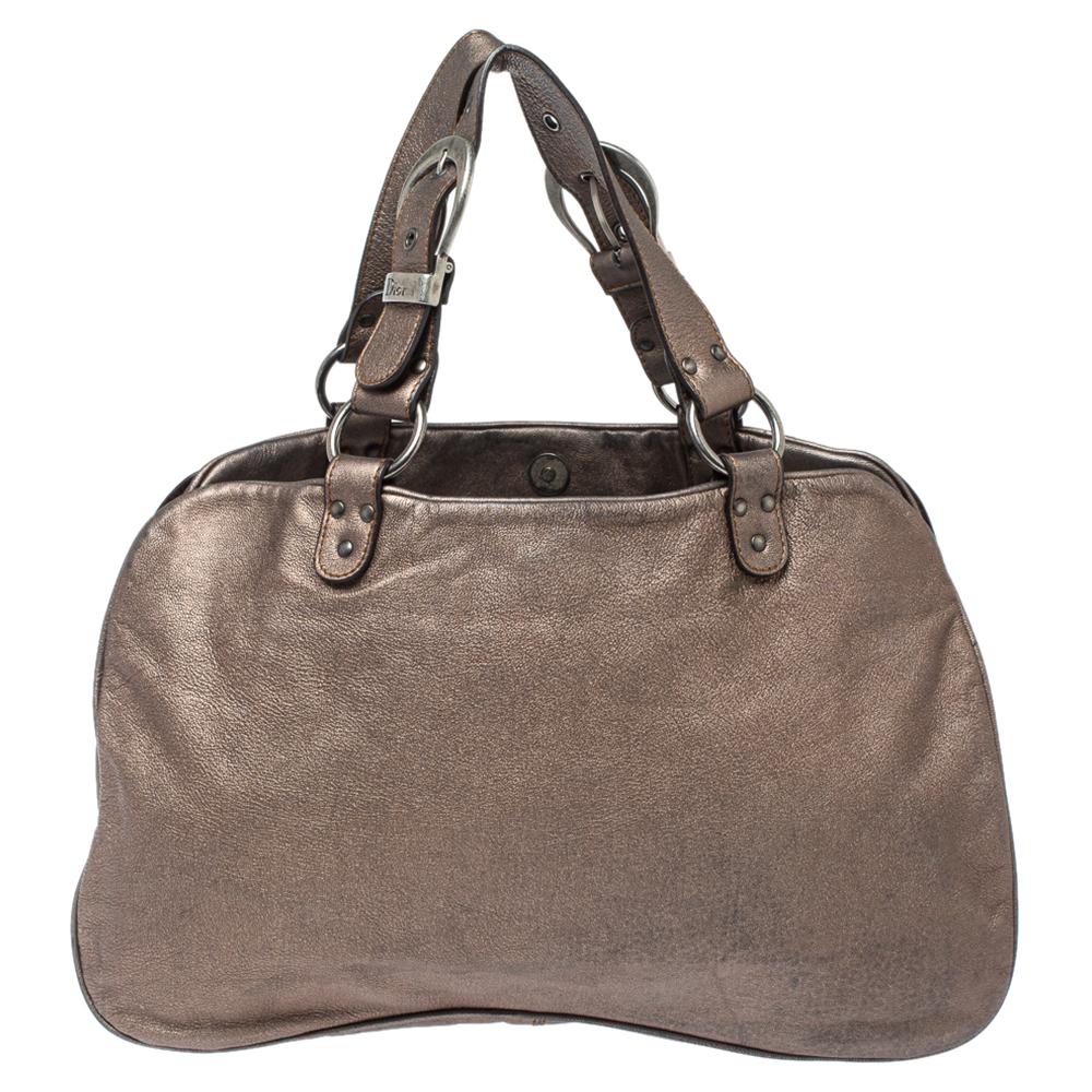 The Dior Saddle made a huge comeback in 2018 and it has gone on to remain in style. Just for you to catch on with the Saddle trend comes this gorgeous version in leather. Dual handles, buckle details, and a nylon interior sum the creation up. The