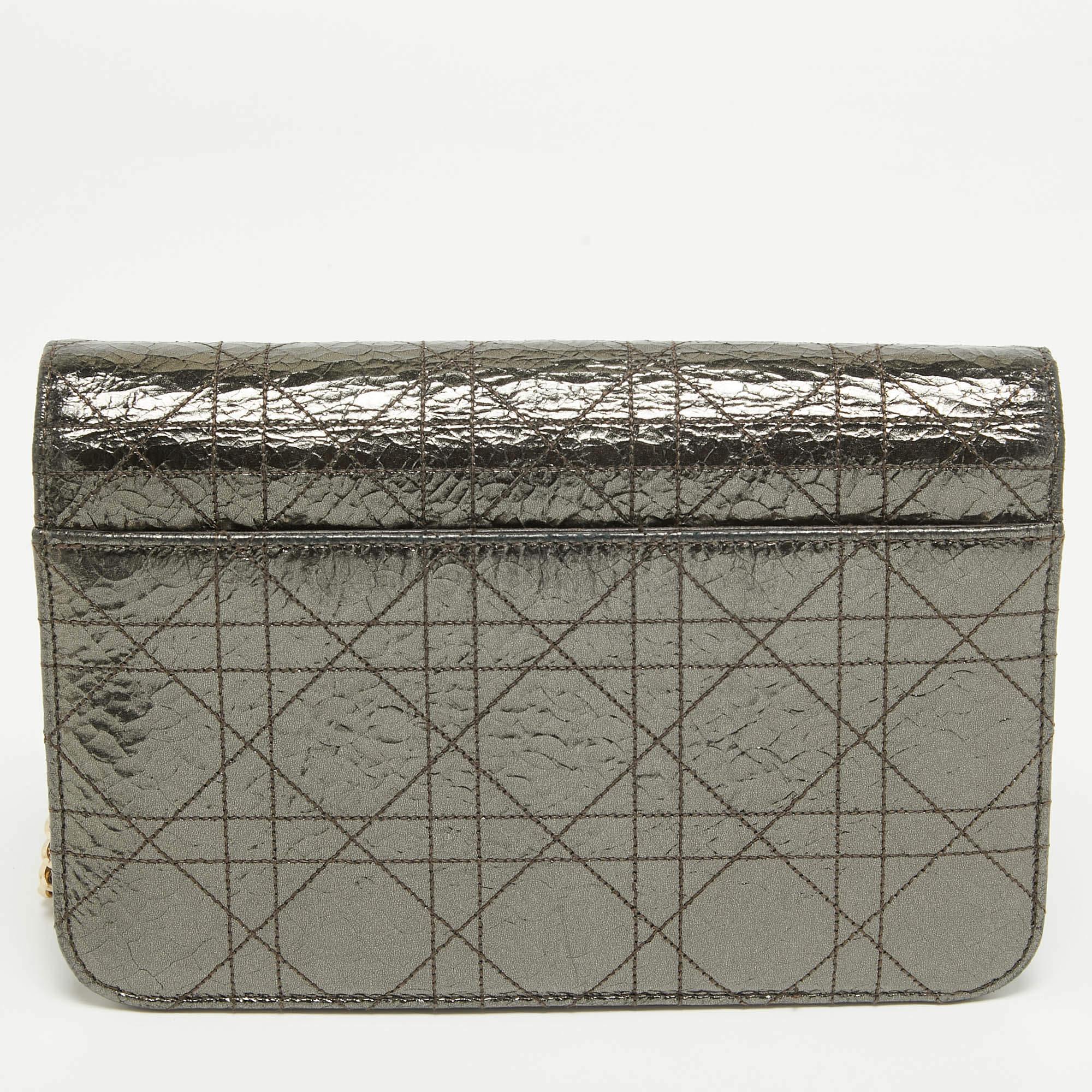 This creation from Dior is so pretty it will surely make a fine buy. Crafted from crackled leather, this Miss Dior Promenade clutch features their signature Cannage quilt all over. The front flap has a Dior lock that opens to a leather-nylon lined