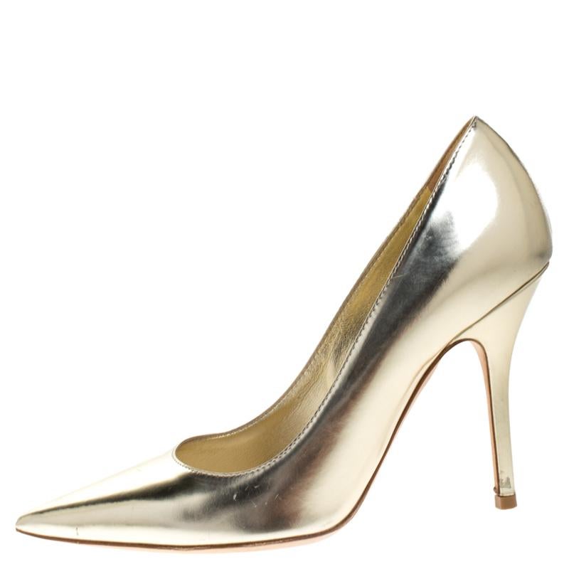 Dior 'Cherie' pumps are designed in metallic gold leather with 10 cm high heels and pointed toes. They make a perfect partner to trousers or pantsuits as the metallic shade beautifully peeps out of the hemline. Carry a matching clutch to complete