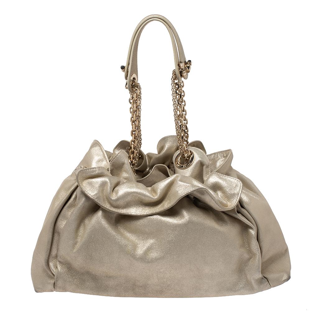 This stylish Le Trente hobo from Dior has been crafted from metallic gold leather that adds a hint of glamour. The bag features dual chain straps with leather shoulder rest, a CD cutout charm in gold-tone metal, a drawstring closure and protective