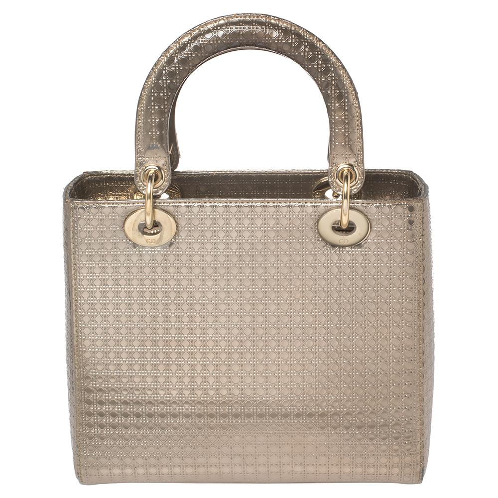 The Lady Dior tote is a Dior creation that has gained recognition worldwide and is today a coveted bag that every fashionista craves to possess. This gold tote has been crafted from leather and it carries the micro Cannage quilt. It is equipped with
