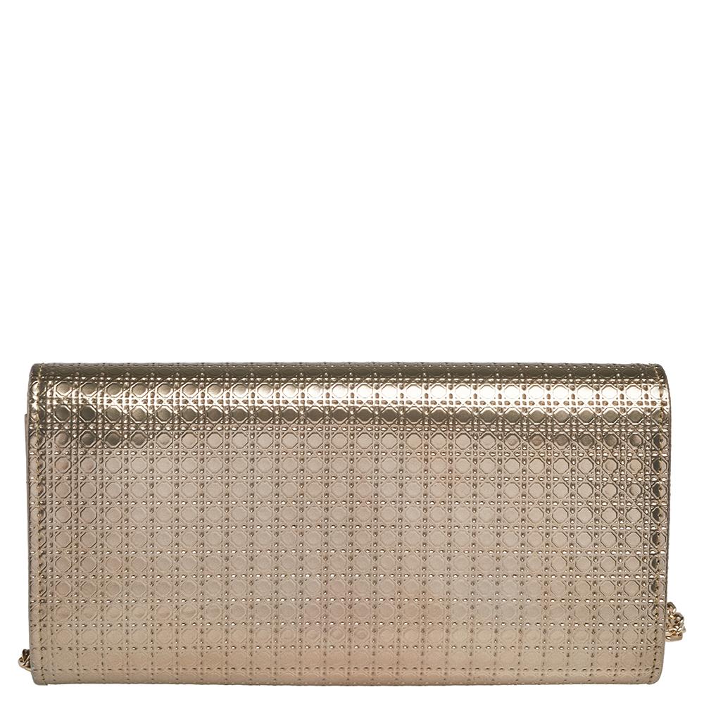 Dior's Croisiere Wallet On Chain arrives in metallic gold Microcannage patent leather. It has a flap design, a leather & fabric interior, and enough space for party essentials. The WOC is complete with a gold-tone chain.

Includes: Original Box,