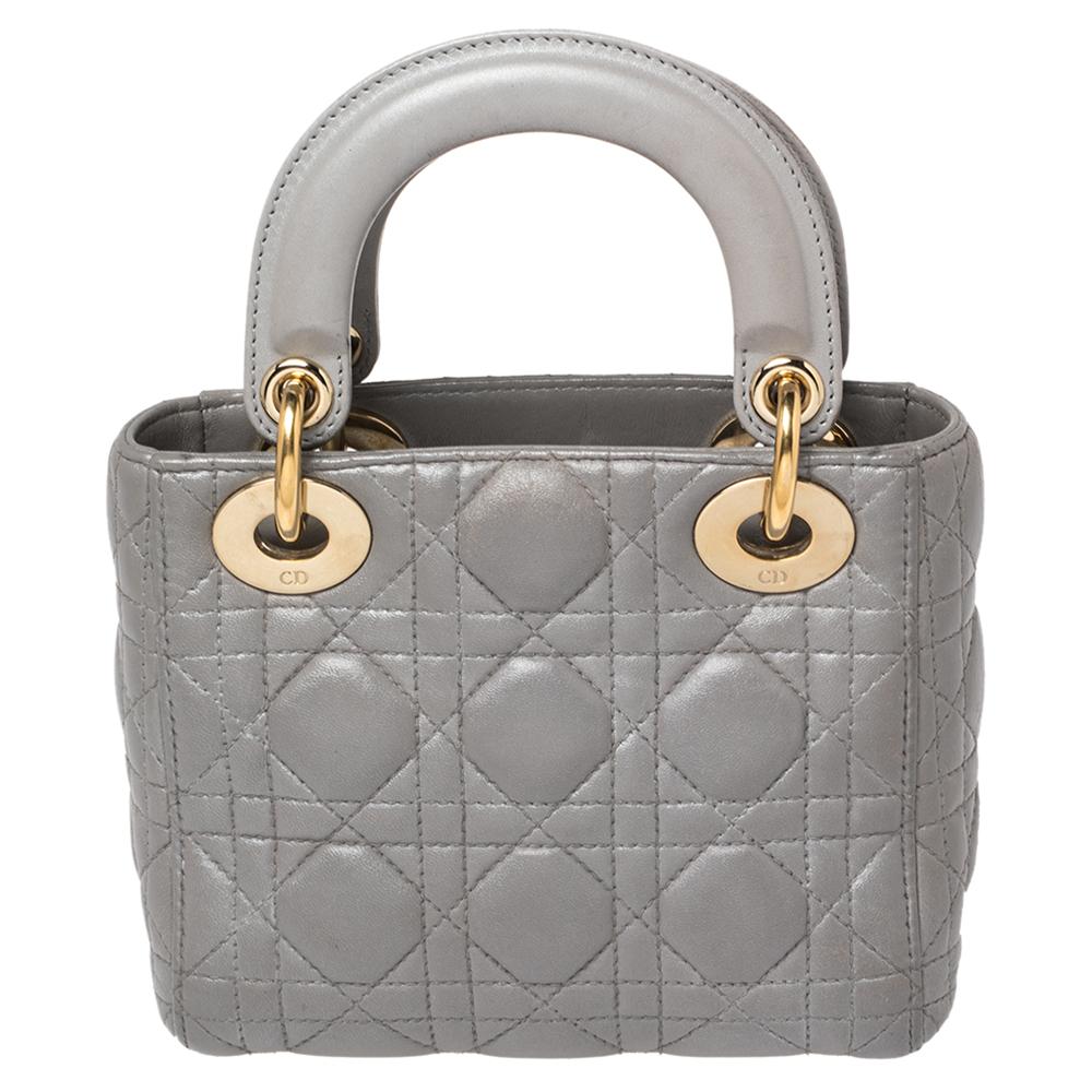The Mini Lady Dior tote is a Dior creation that has gained recognition worldwide and has become a coveted bag that every fashionista craves to possess. This metallic grey tote has been crafted from leather and carries the signature Cannage quilt. It