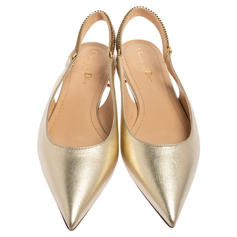 These popular flats exude an elegant and sophisticated aesthetic. Crafted from leather in a metallic light gold shade, the sandals have a sleek design with pointed toes. Adorned with slingbacks featuring embellishments, these exceptional beauties